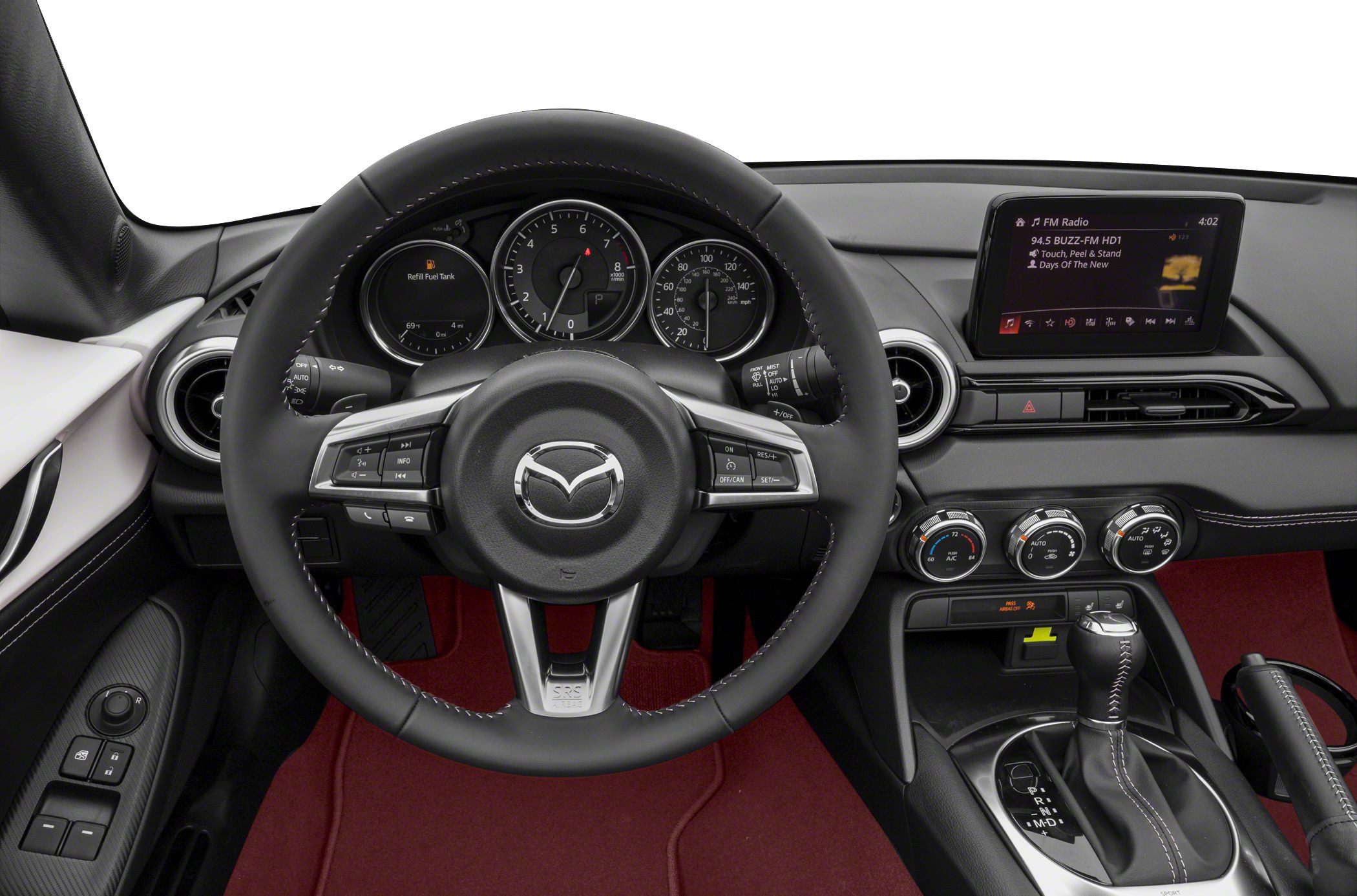 Steering wheel, dashboard, climate controls, red floor mats