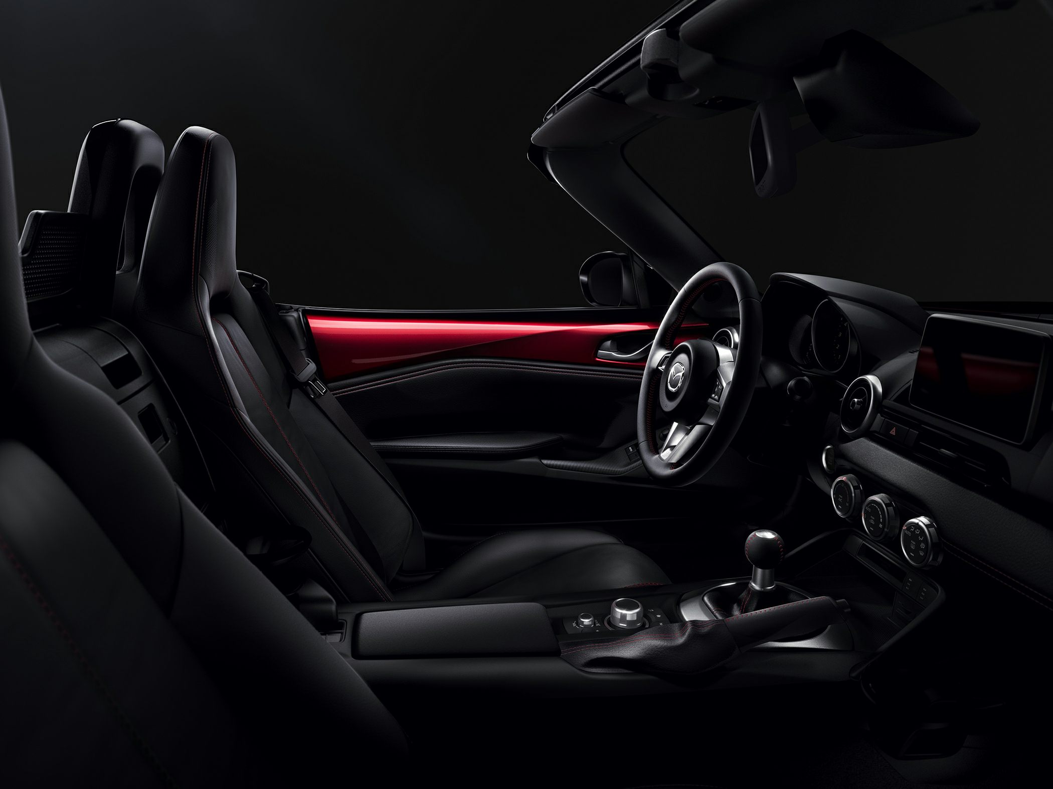 Sporty car interior with leather seats, manual shifter, and modern dashboard design