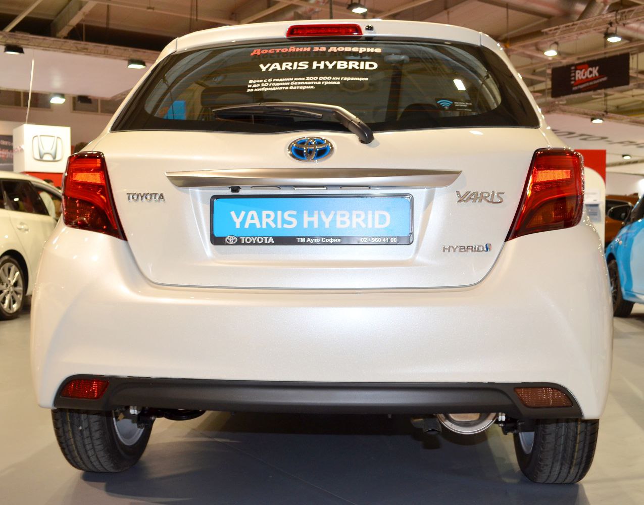 Rear view of a compact hybrid hatchback with distinct tail lights and badges