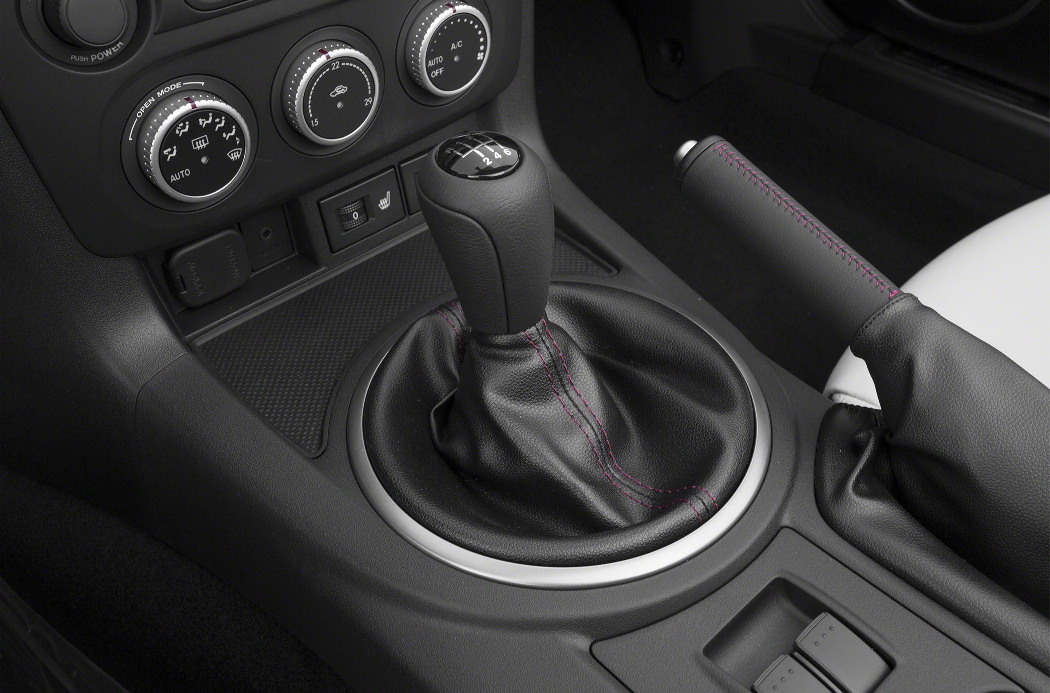 Manual gear shift lever and handbrake with red stitching detail