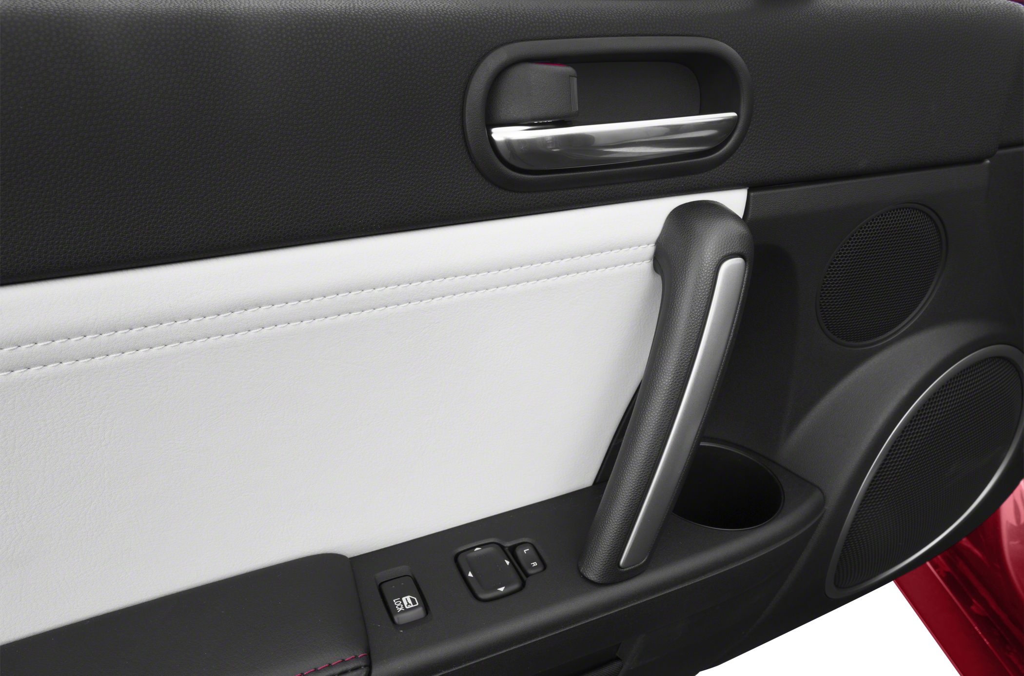 Door panel with window controls, armrest, handle, and speaker