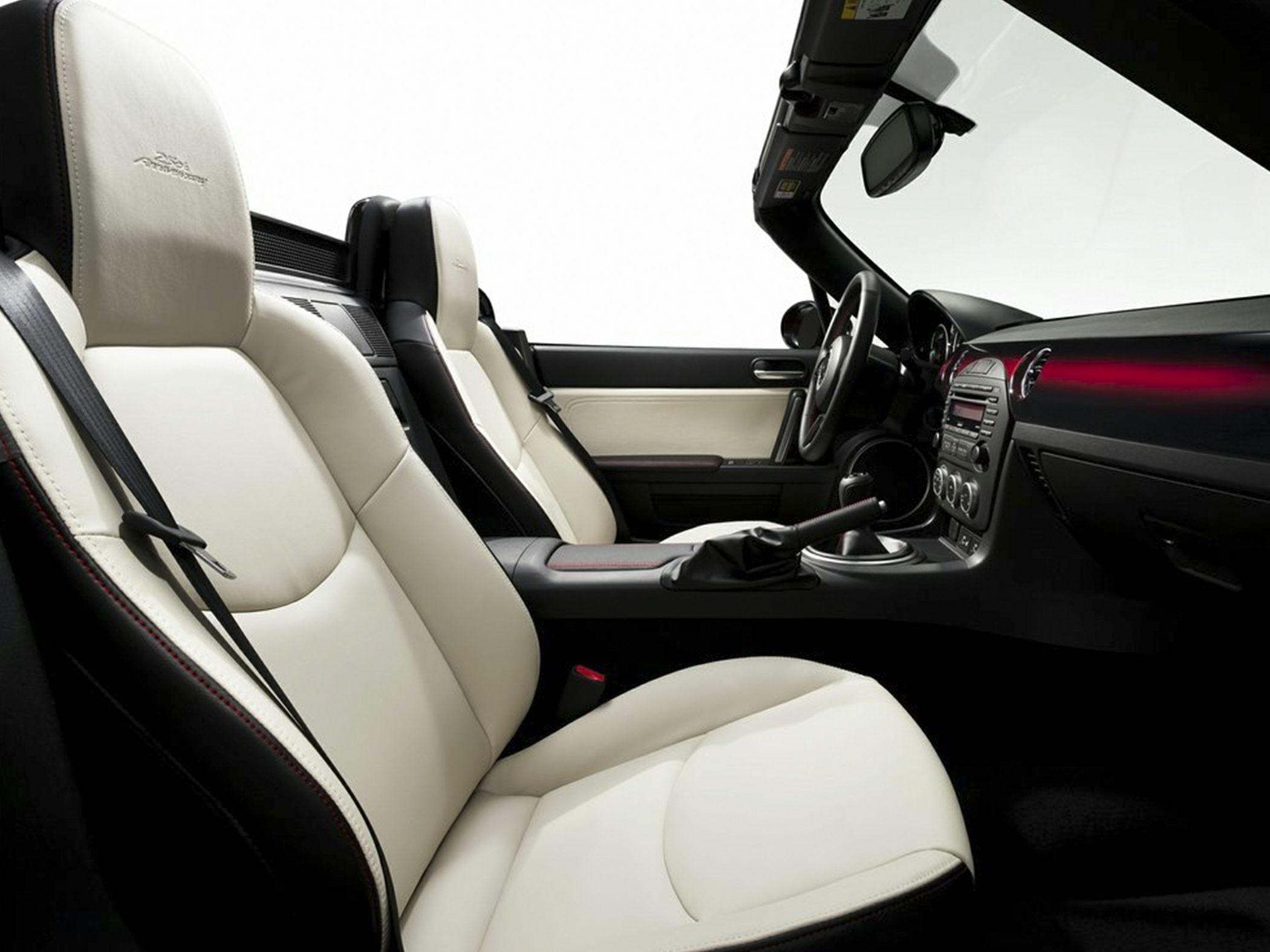 White leather seats and modern dashboard of a sports convertible interior.