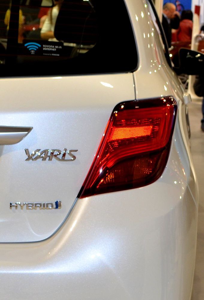 Rear light and hybrid badge close-up on a hatchback.