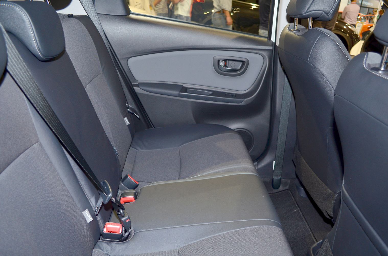 Rear seat and door panel interior with seatbelts and upholstery.