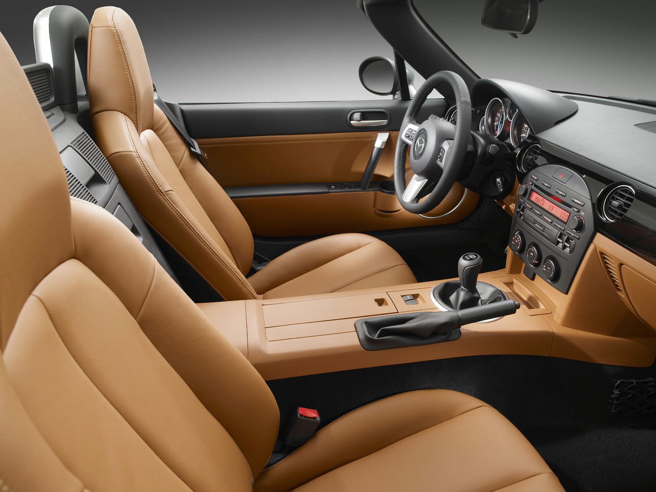 Tan leather interior with manual transmission and detailed dashboard.