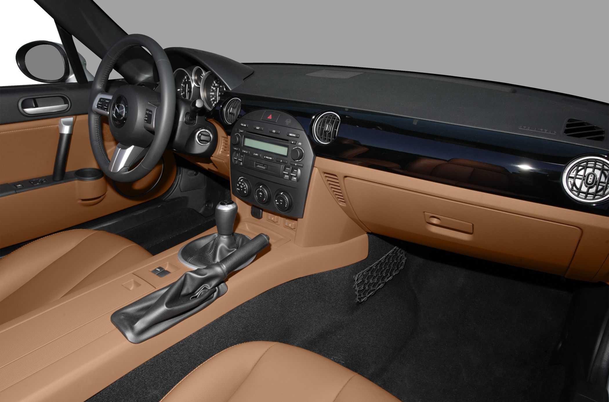 Manual gear shift and dashboard with steering wheel in car interior