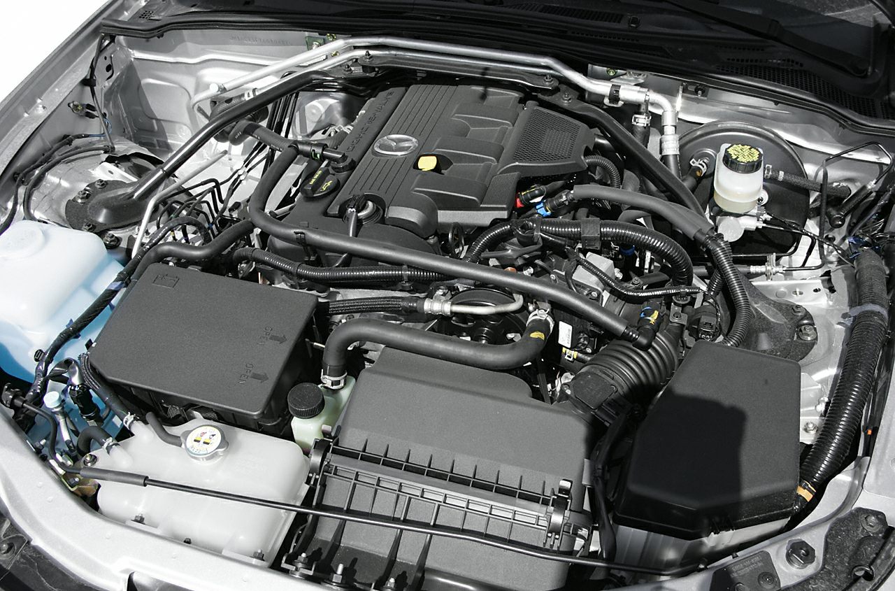 Detailed view of a compact sports car engine bay with visible components and hoses