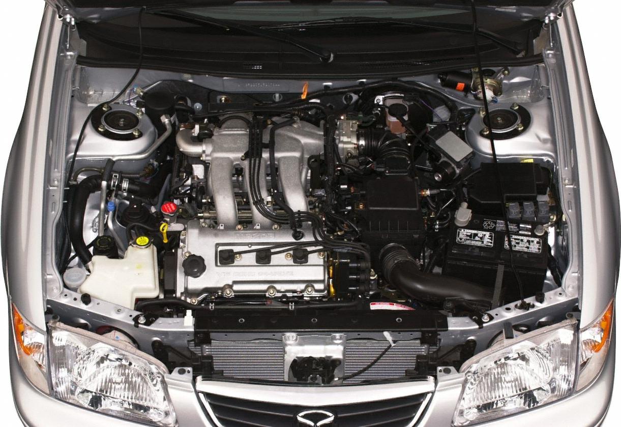 Clean engine bay with visible intake manifold and battery.