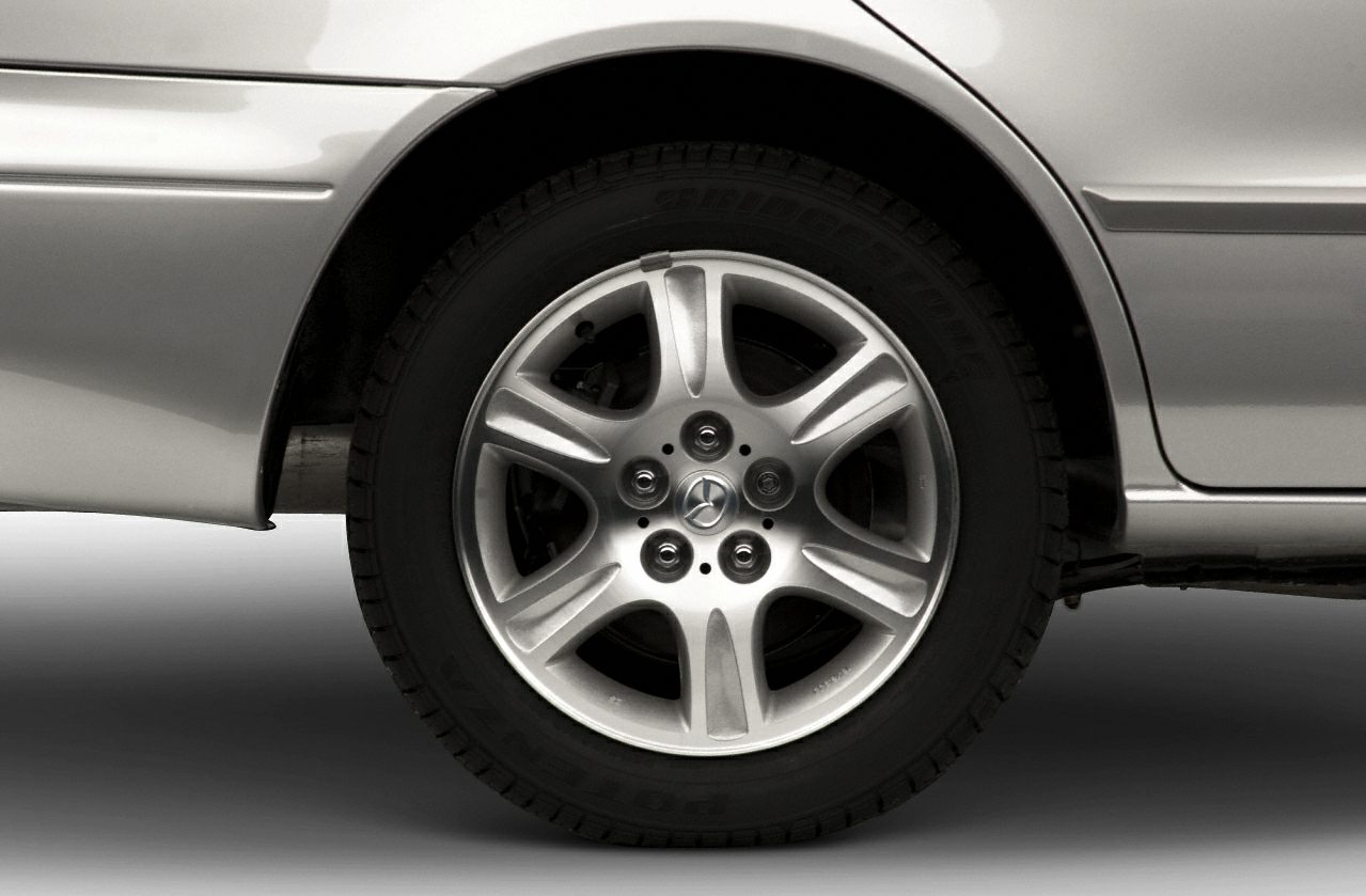 Alloy wheel and tire close-up with five-spoke design and Bridgestone tire tread.