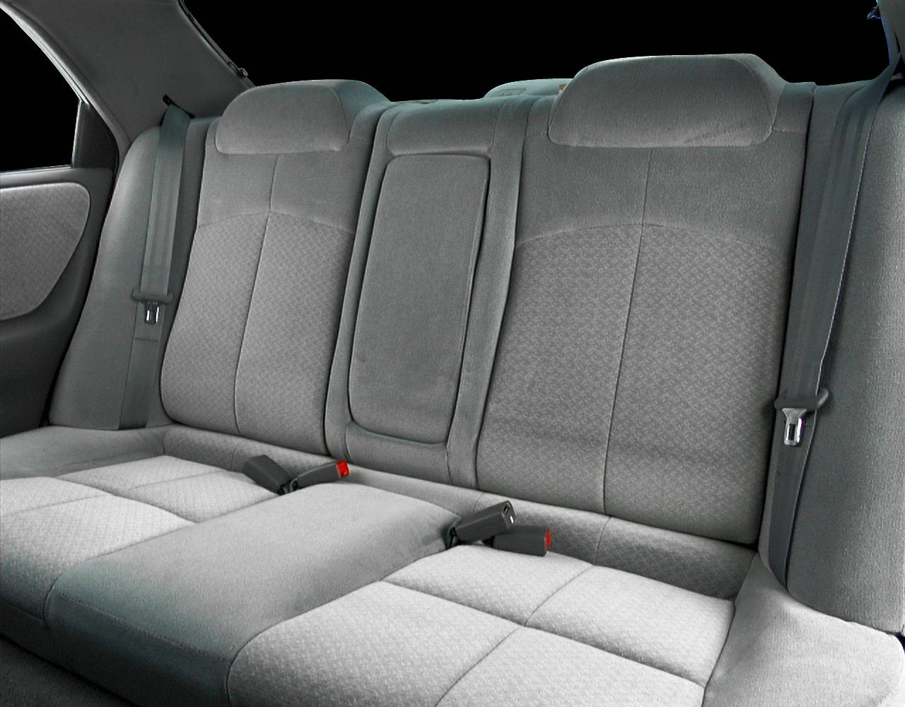 Rear fabric seats with seatbelts and headrests in a sedan interior
