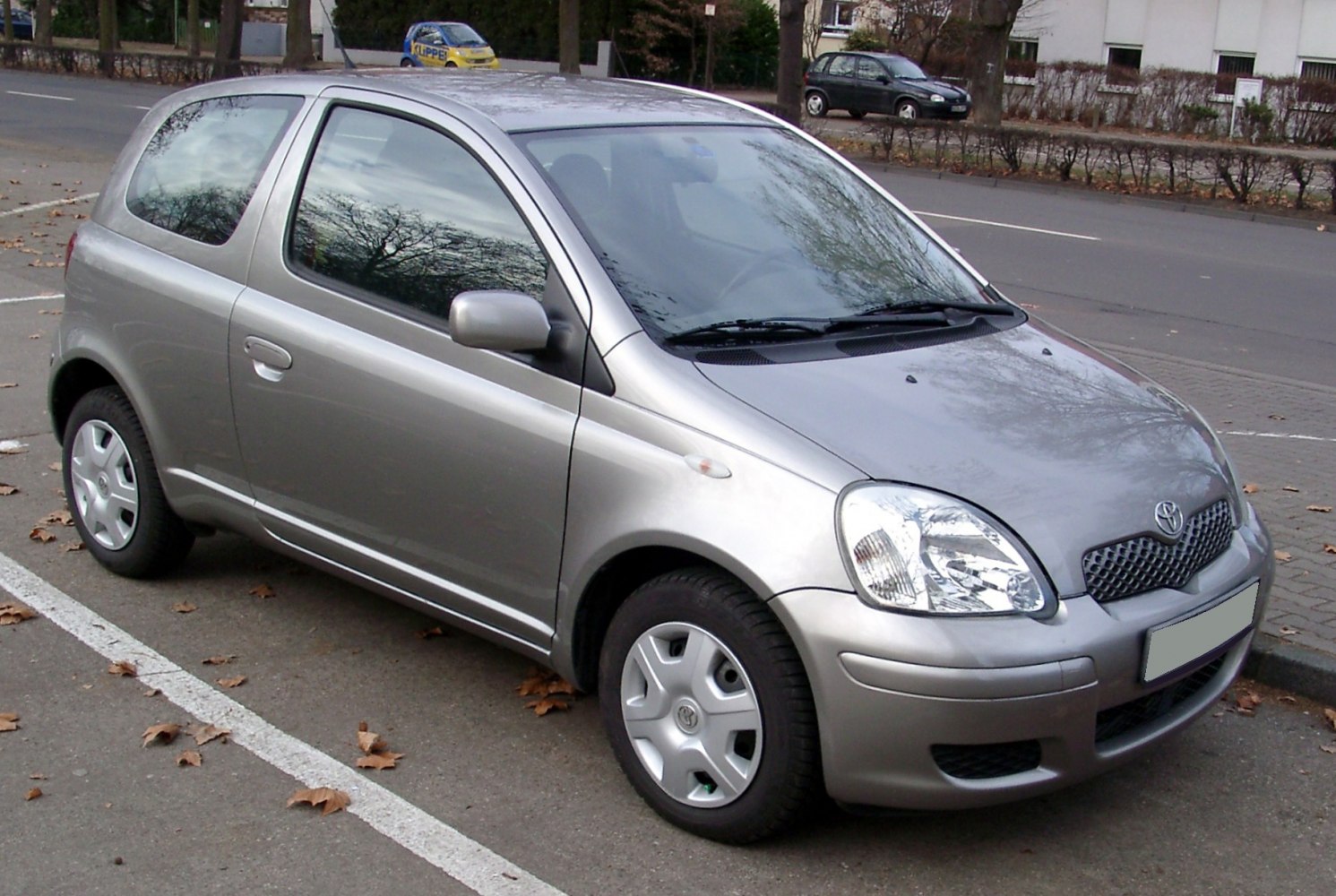 Compact 3-door hatchback with rounded headlights and smooth body lines.