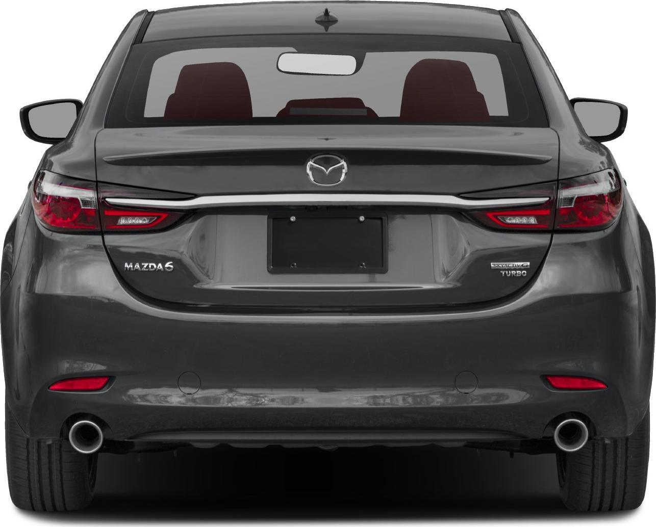 Rear view with slim tail lights, dual exhausts, and rear emblem