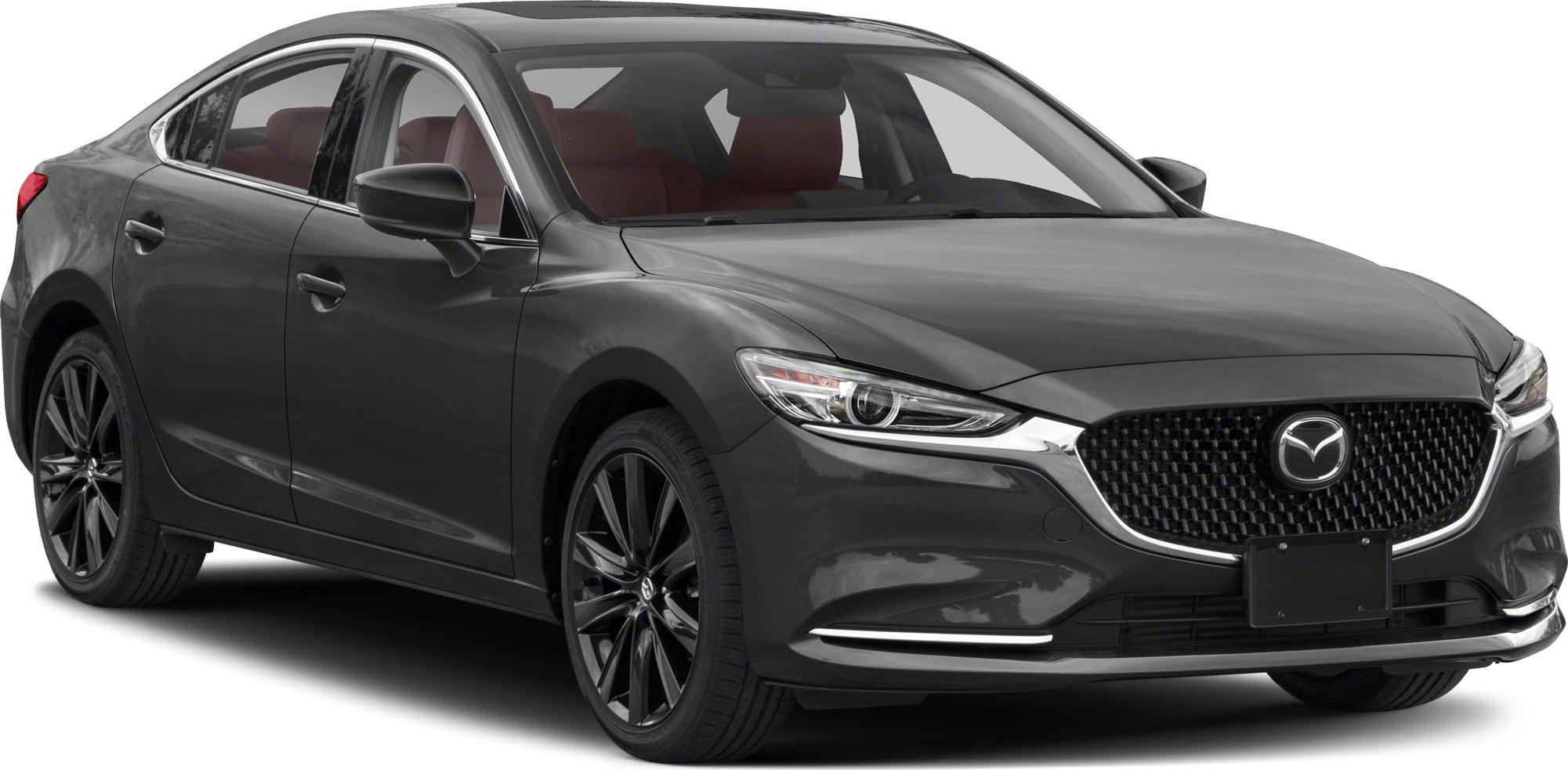 Front angle view of sedan with sleek headlights and black multi-spoke wheels
