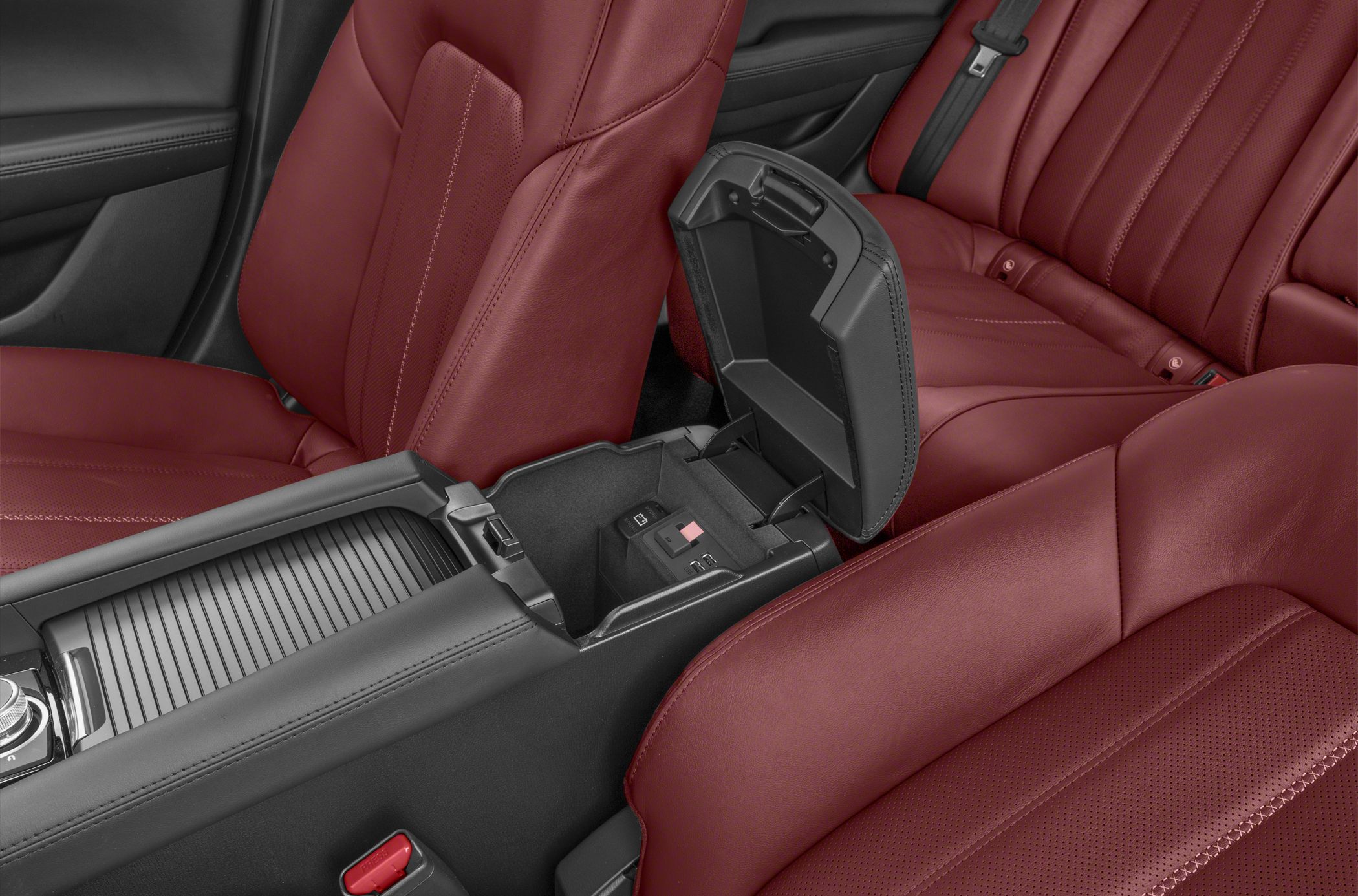 Red leather seats and open center console with storage compartment