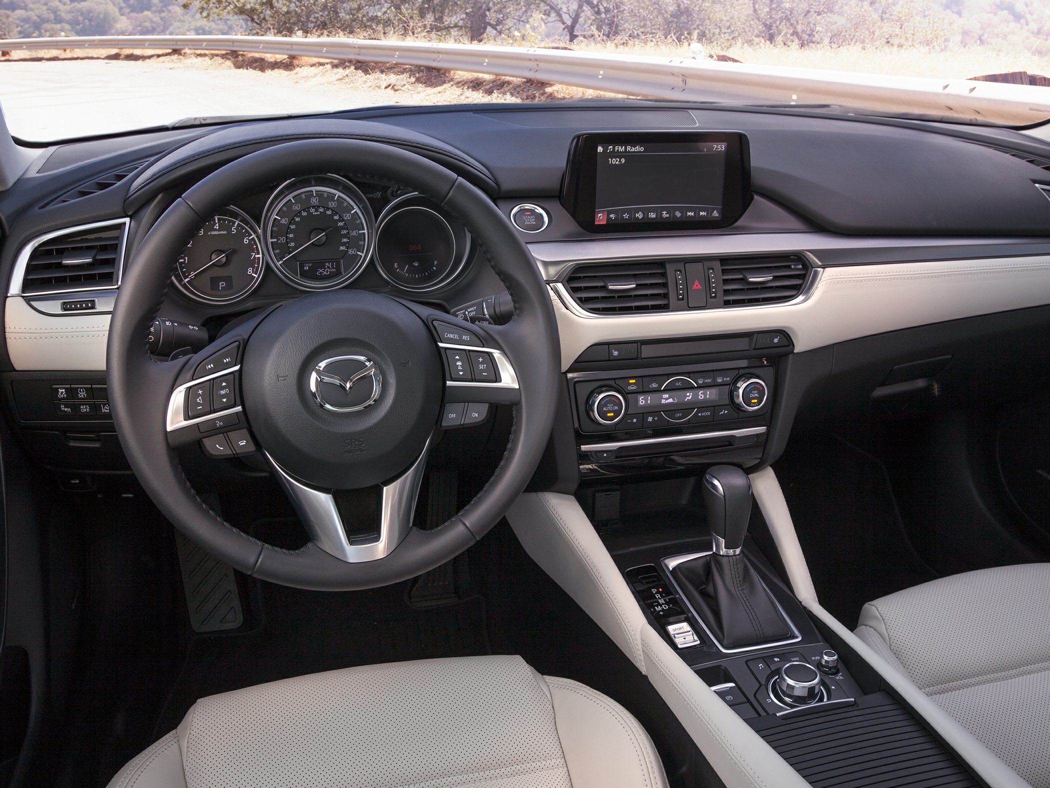 Dashboard, steering wheel, and center console with infotainment and climate controls