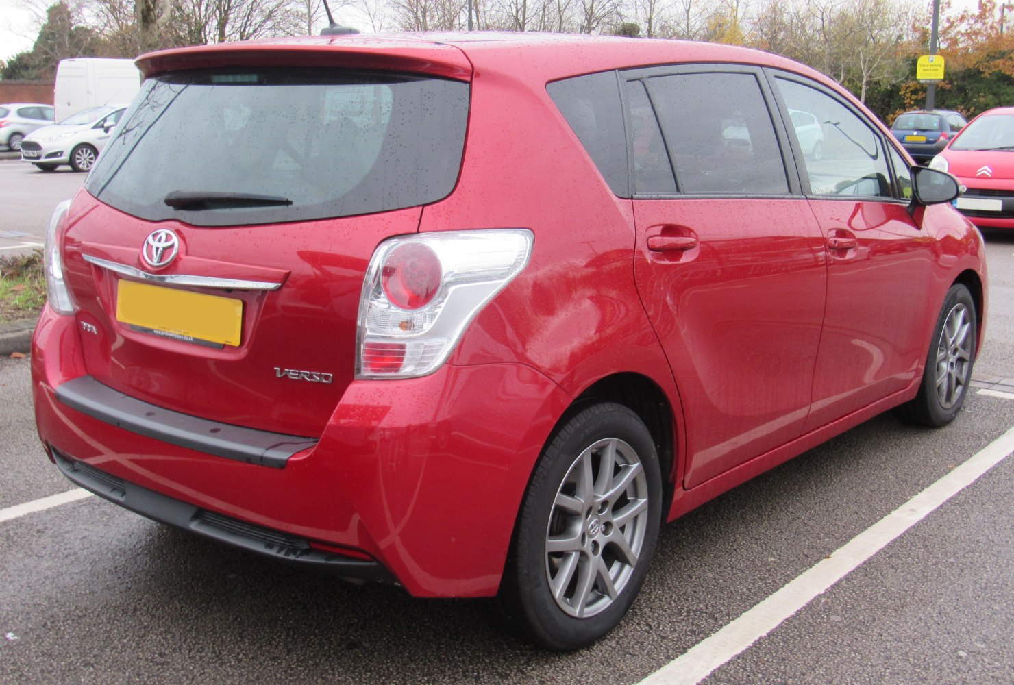Red rear and side view with taillights and alloy wheels