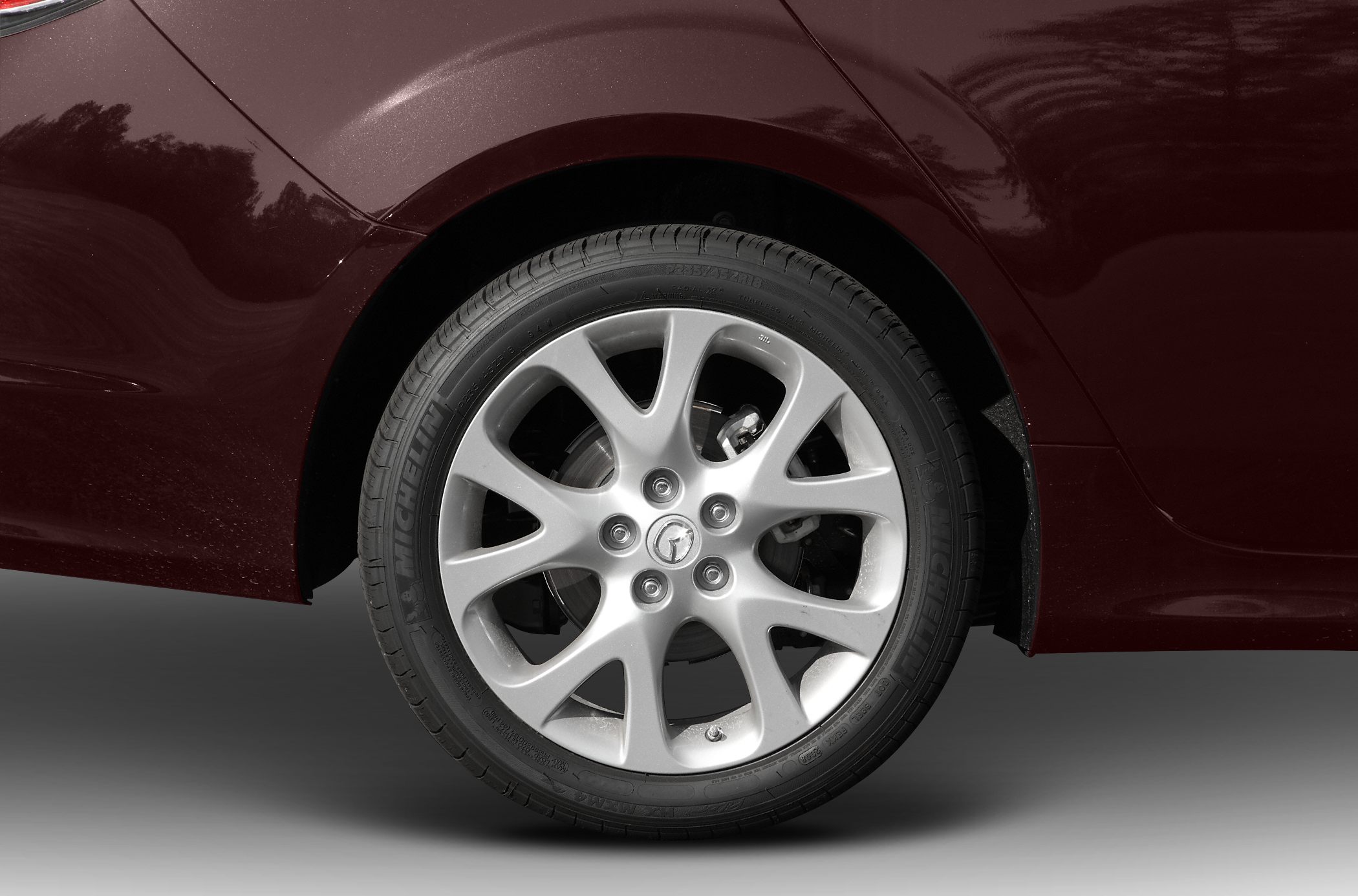 Alloy wheel rim with Michelin tire on sedan vehicle