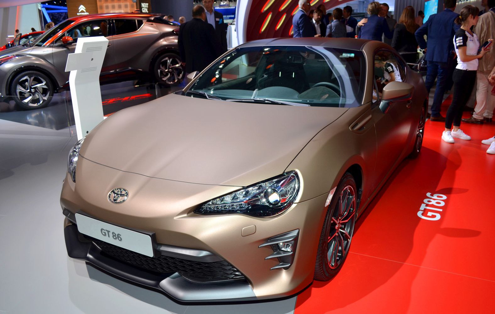 Front and side view of sporty coupe with updated headlights and aerodynamic front fascia.