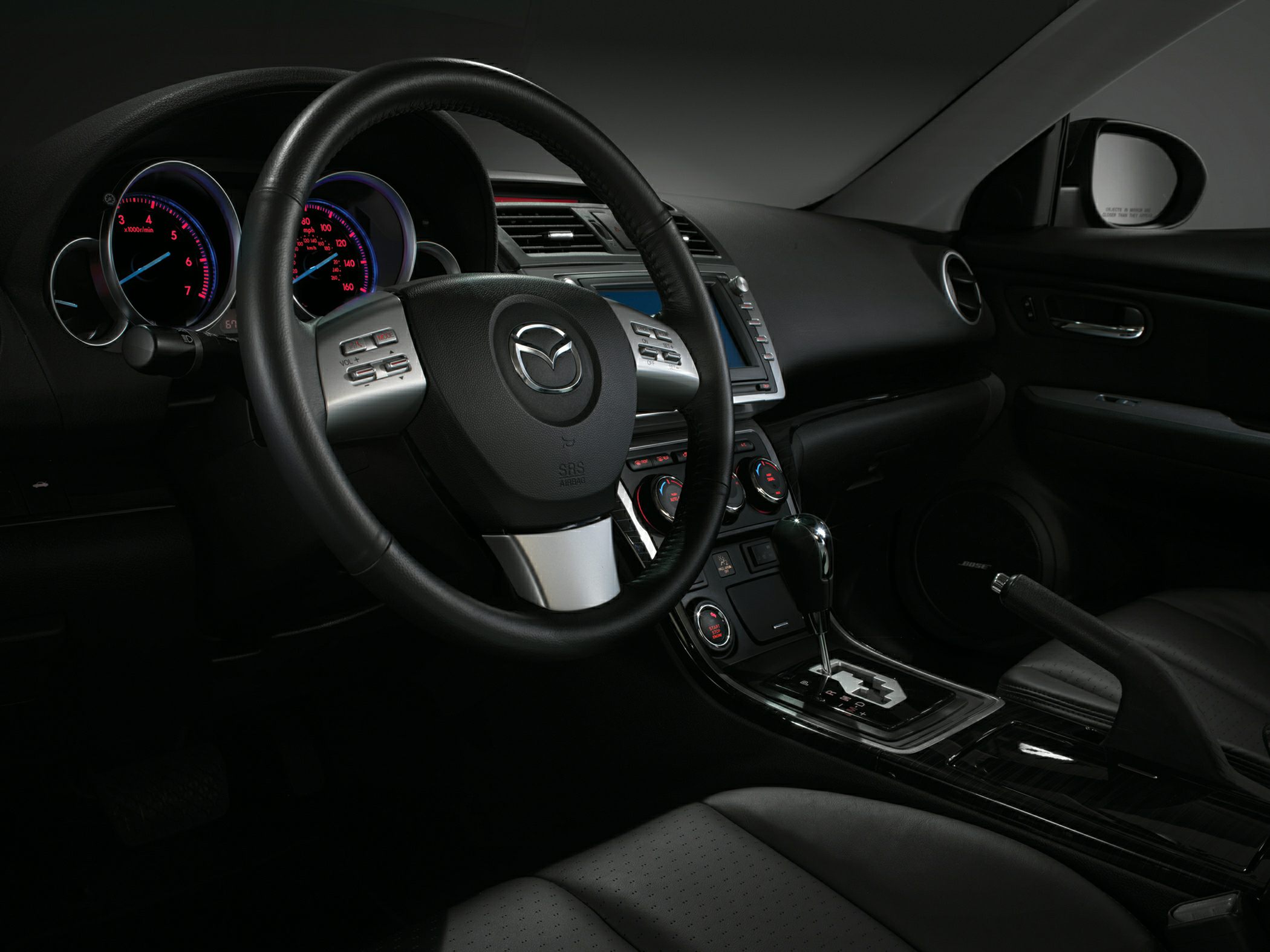 Steering wheel, dashboard gauges, center console with gear shift
