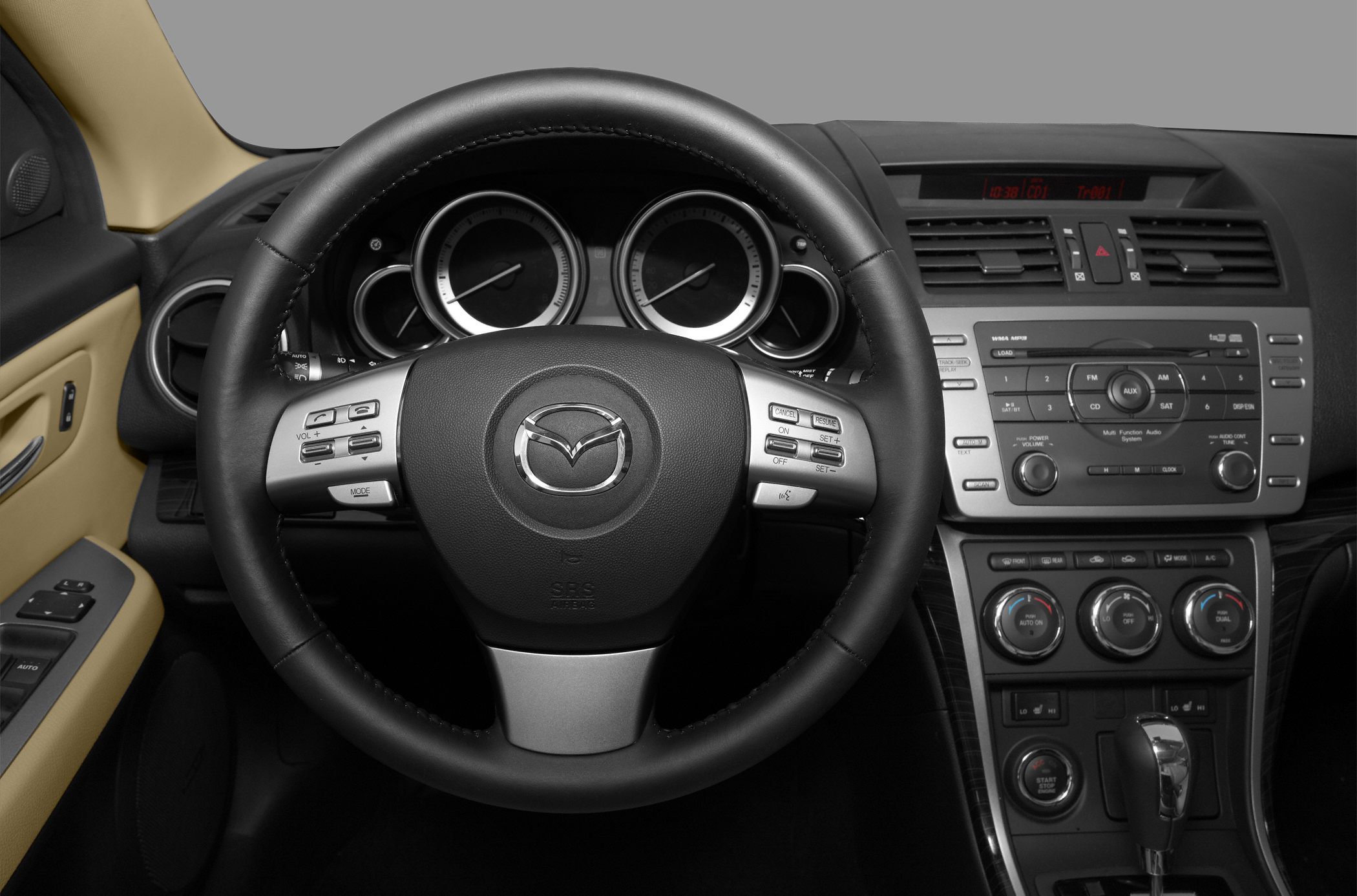 Steering wheel, instrument cluster, and dashboard controls including climate and audio system.