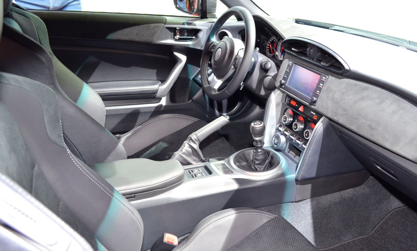 Sports car interior with manual gearbox and modern dashboard