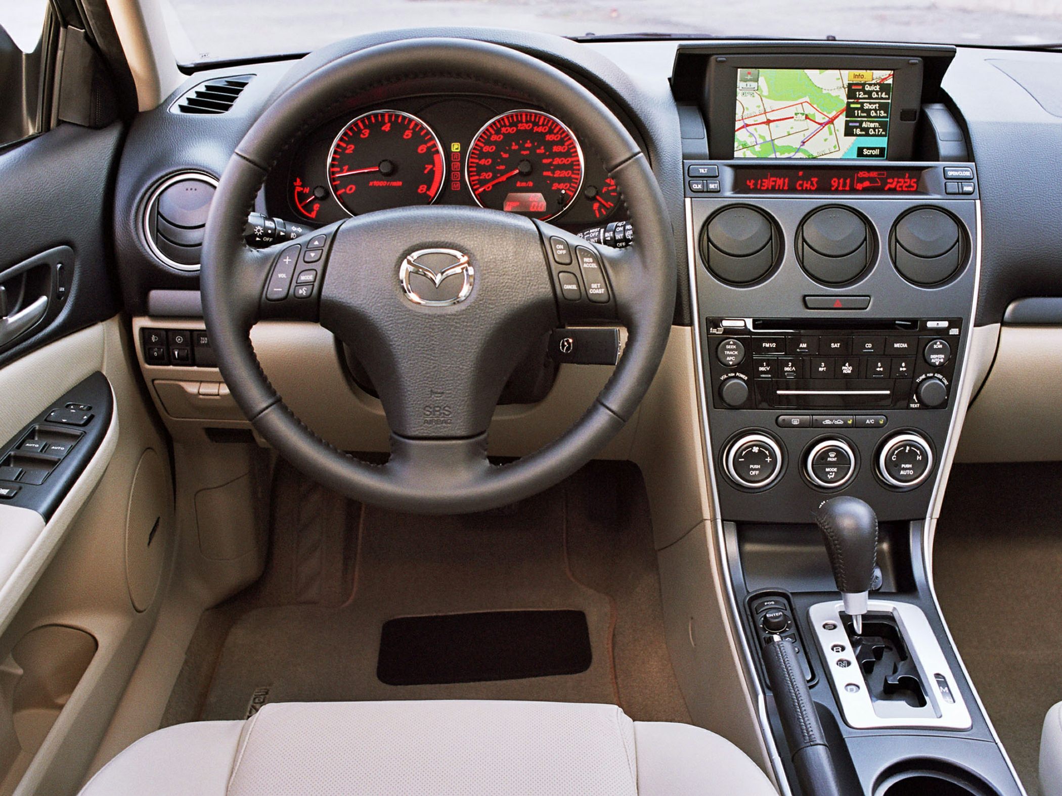 Steering wheel with controls and a detailed dashboard with navigation screen