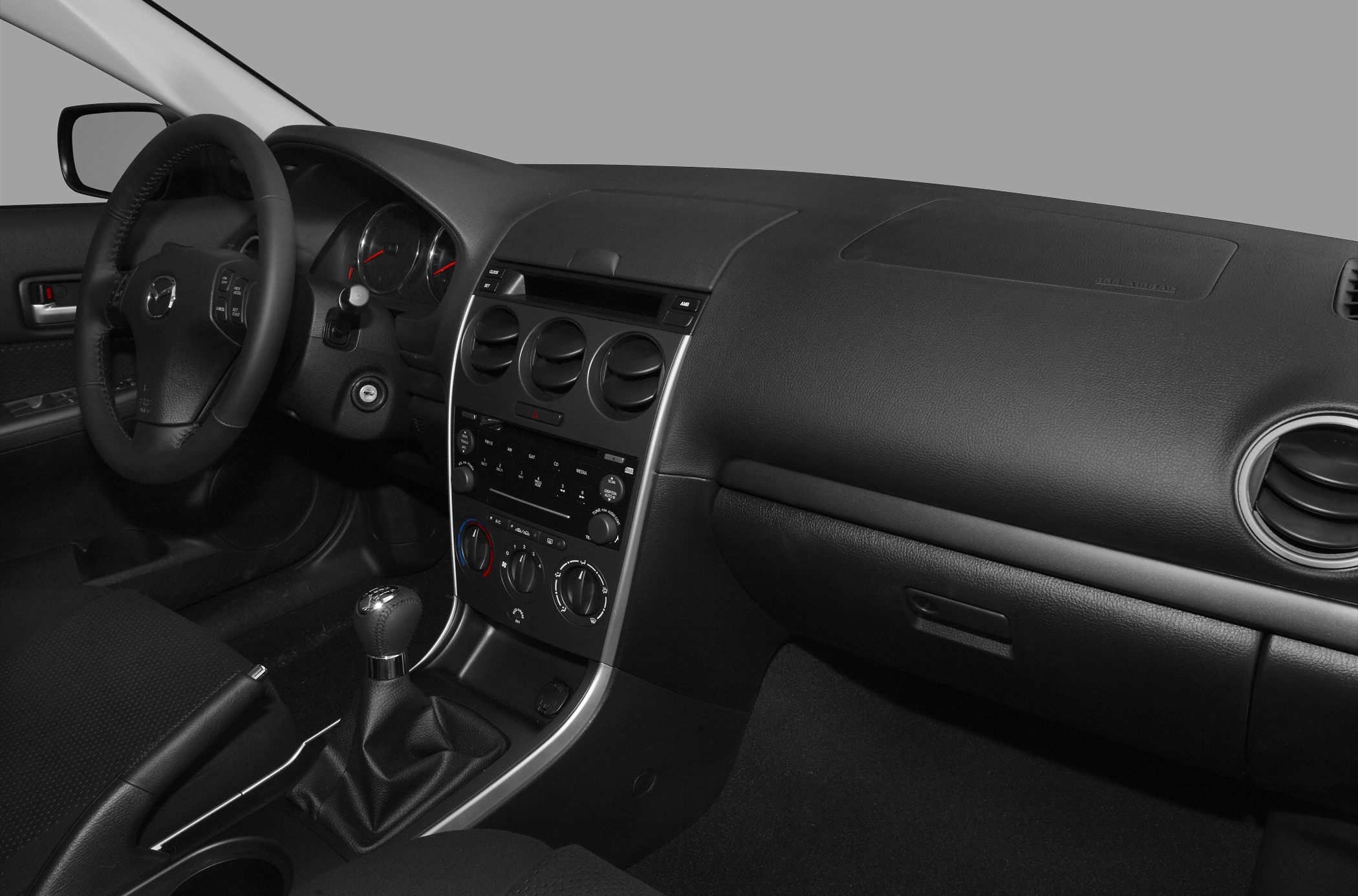 Black interior dashboard, steering wheel, and manual gear shift