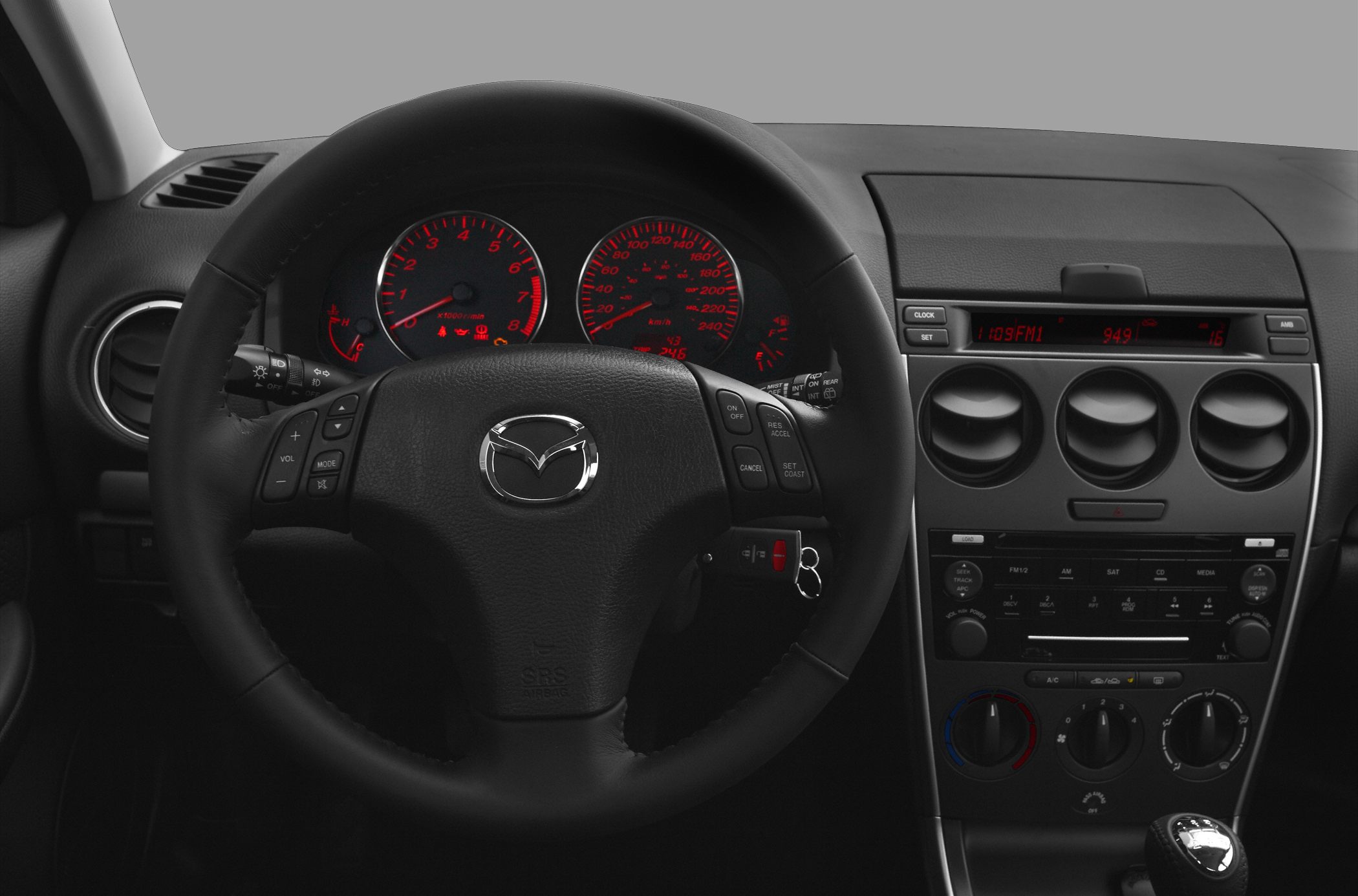 Dashboard and steering wheel with illuminated instrument cluster and control buttons