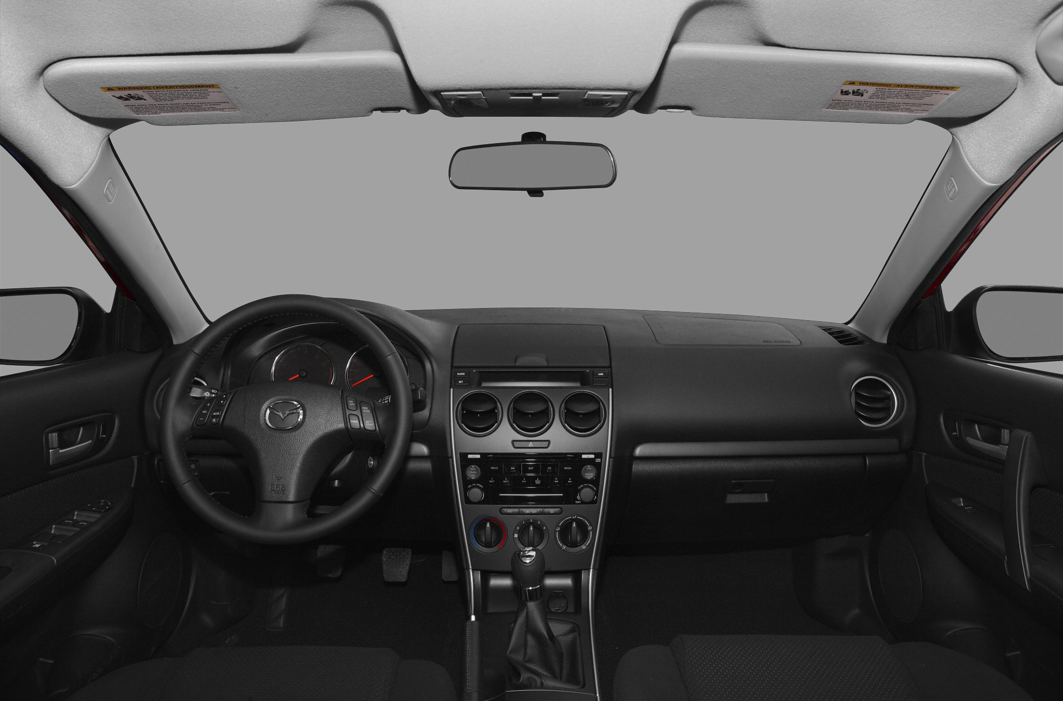 Car interior with dashboard, steering wheel, and manual gear shift