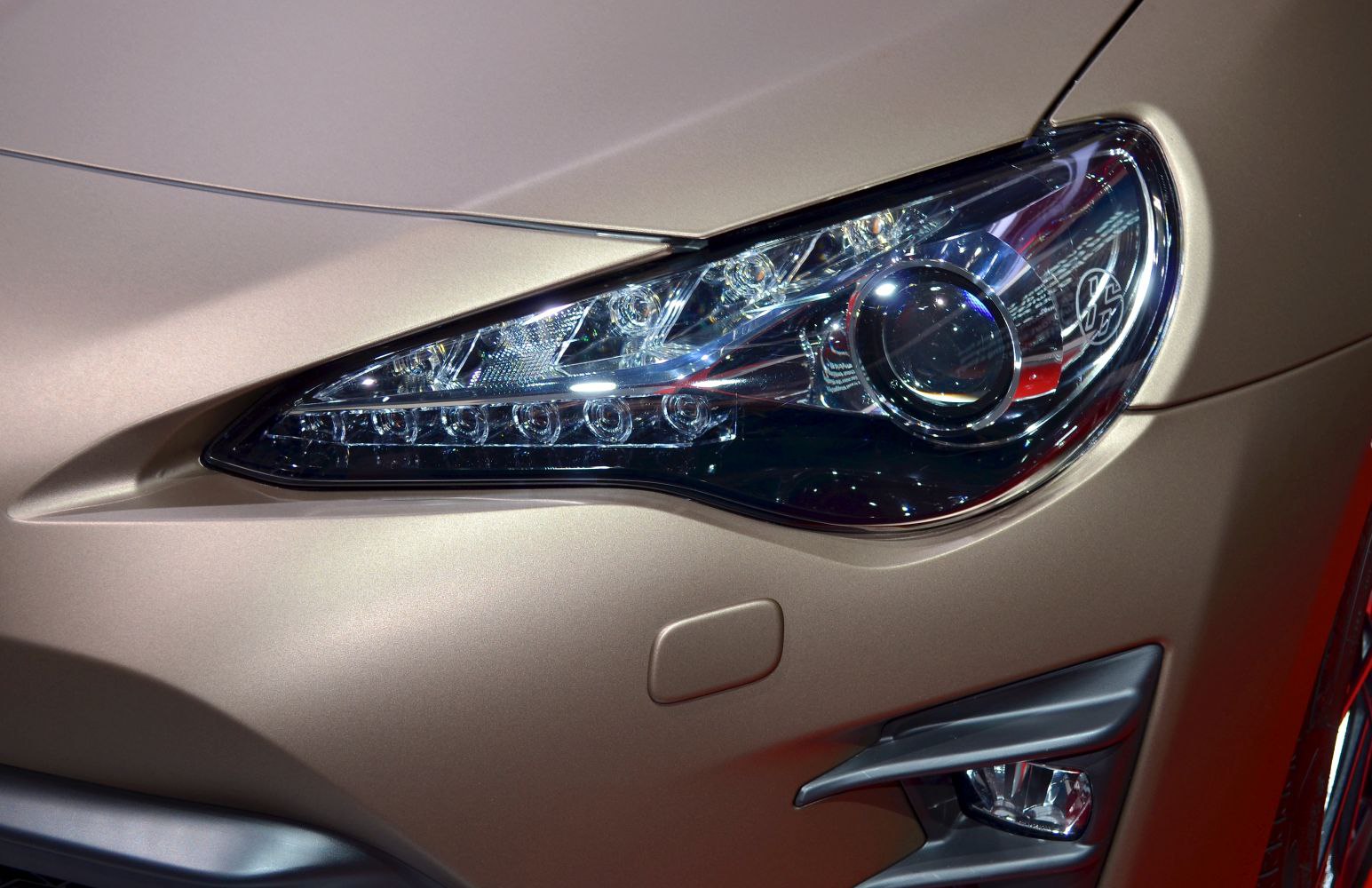 Close-up of a modern LED projector headlight with detailed design elements
