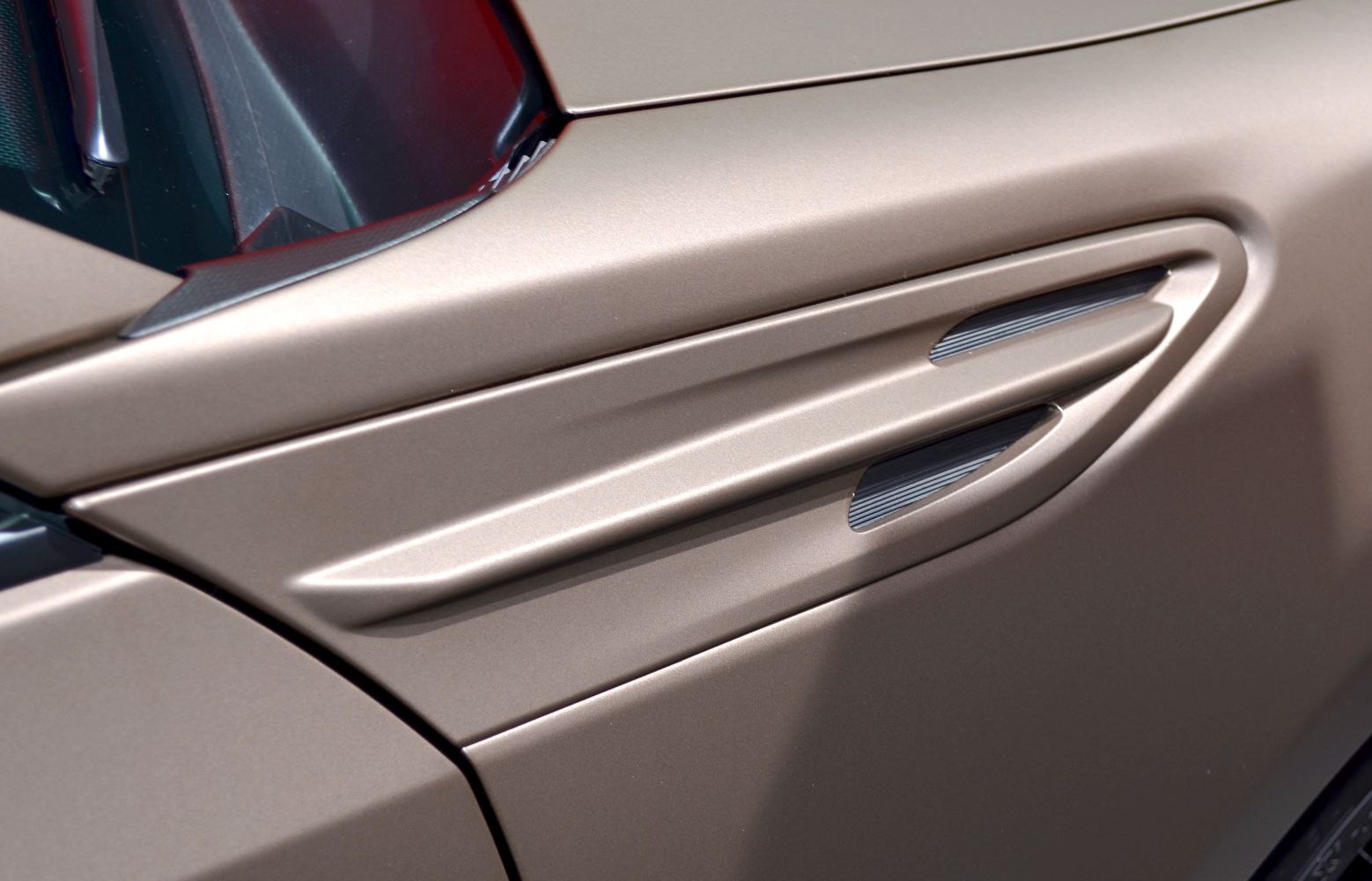 Close-up of side vent and trim detail on metallic body panel