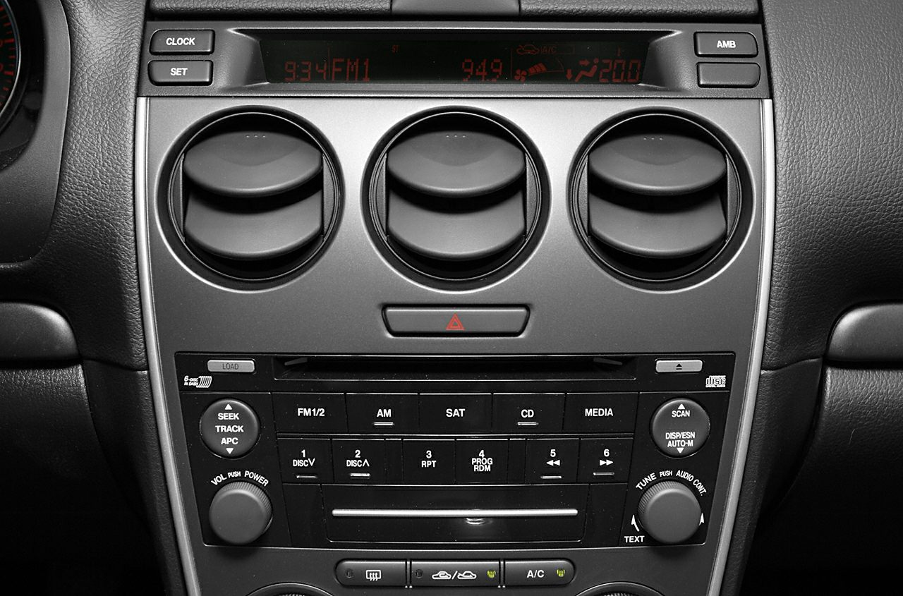 Car interior with round air vents, digital display, and audio controls