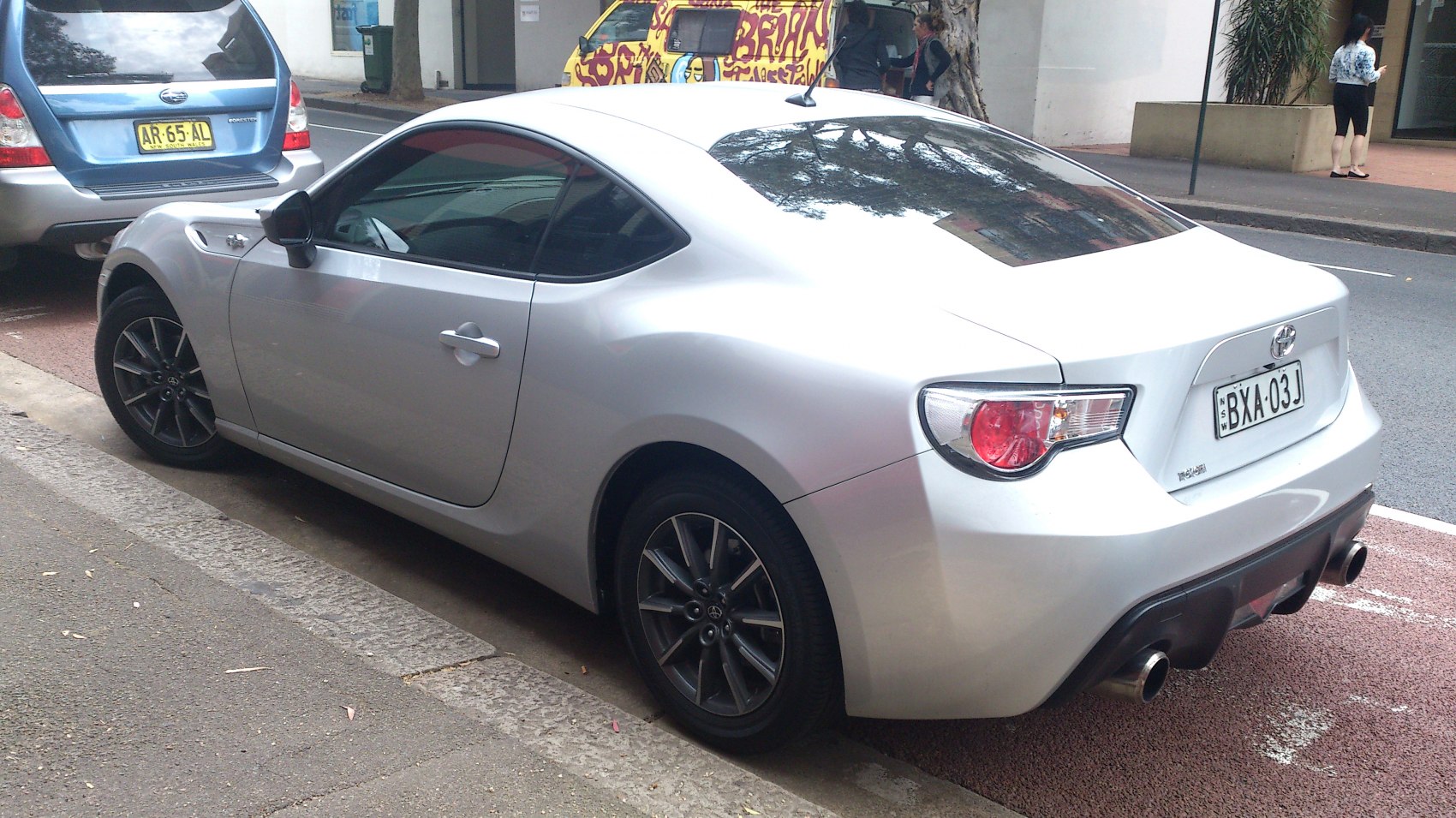 Silver sports coupe with dual exhaust and alloy wheels