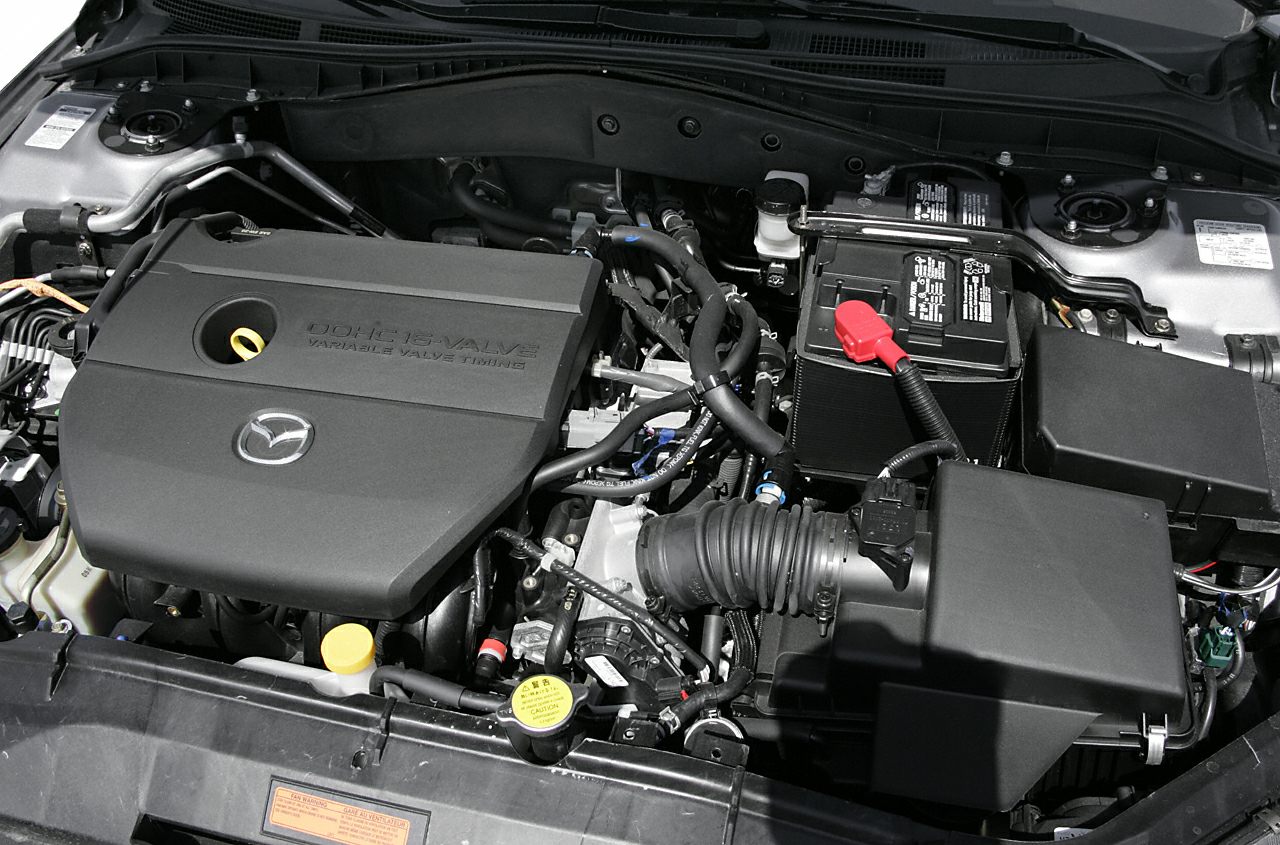 DOHC 16-valve engine with variable valve timing in a car engine bay