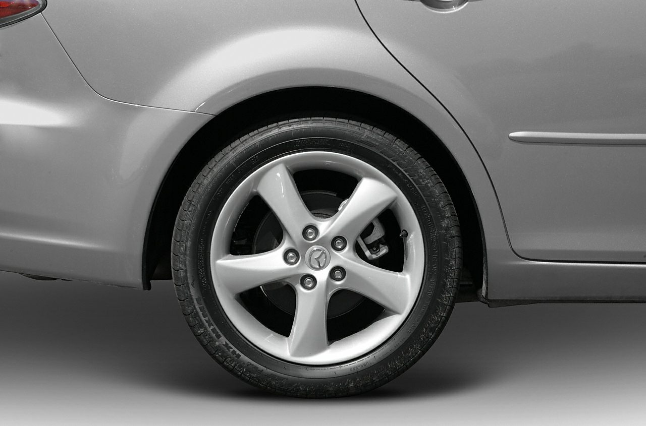Close-up of alloy wheel and rear fender of sedan