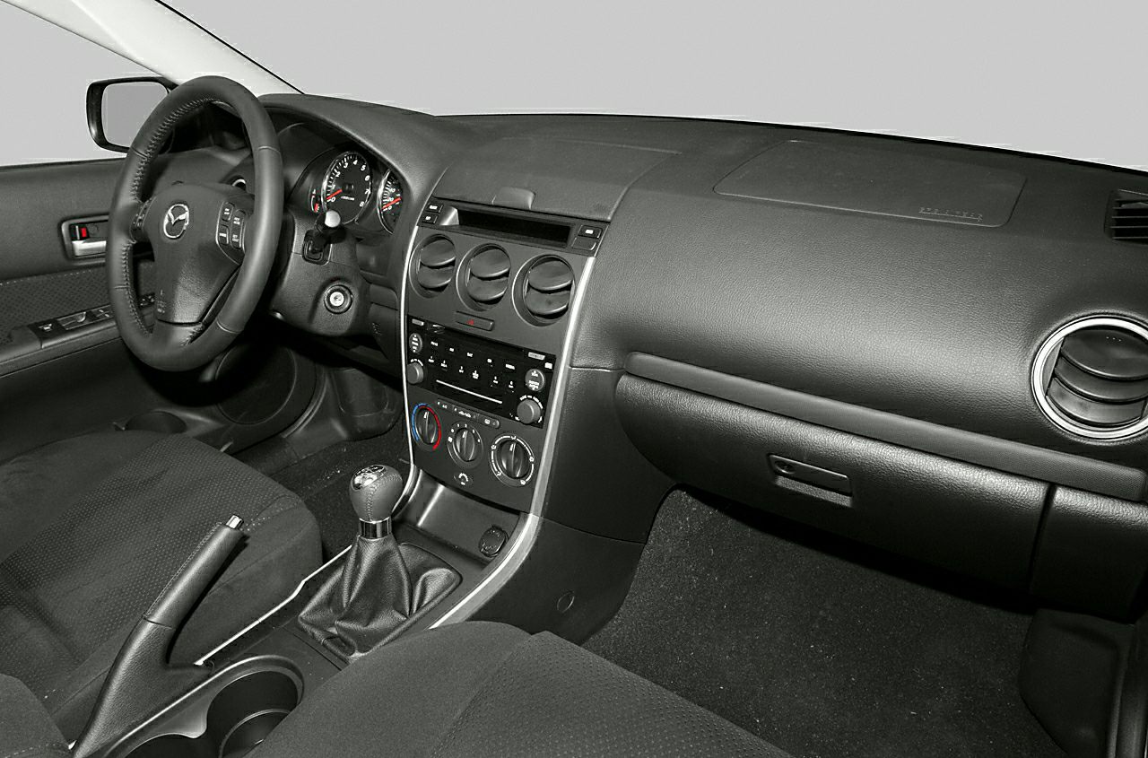 Black car interior with manual gear shift and dashboard layout