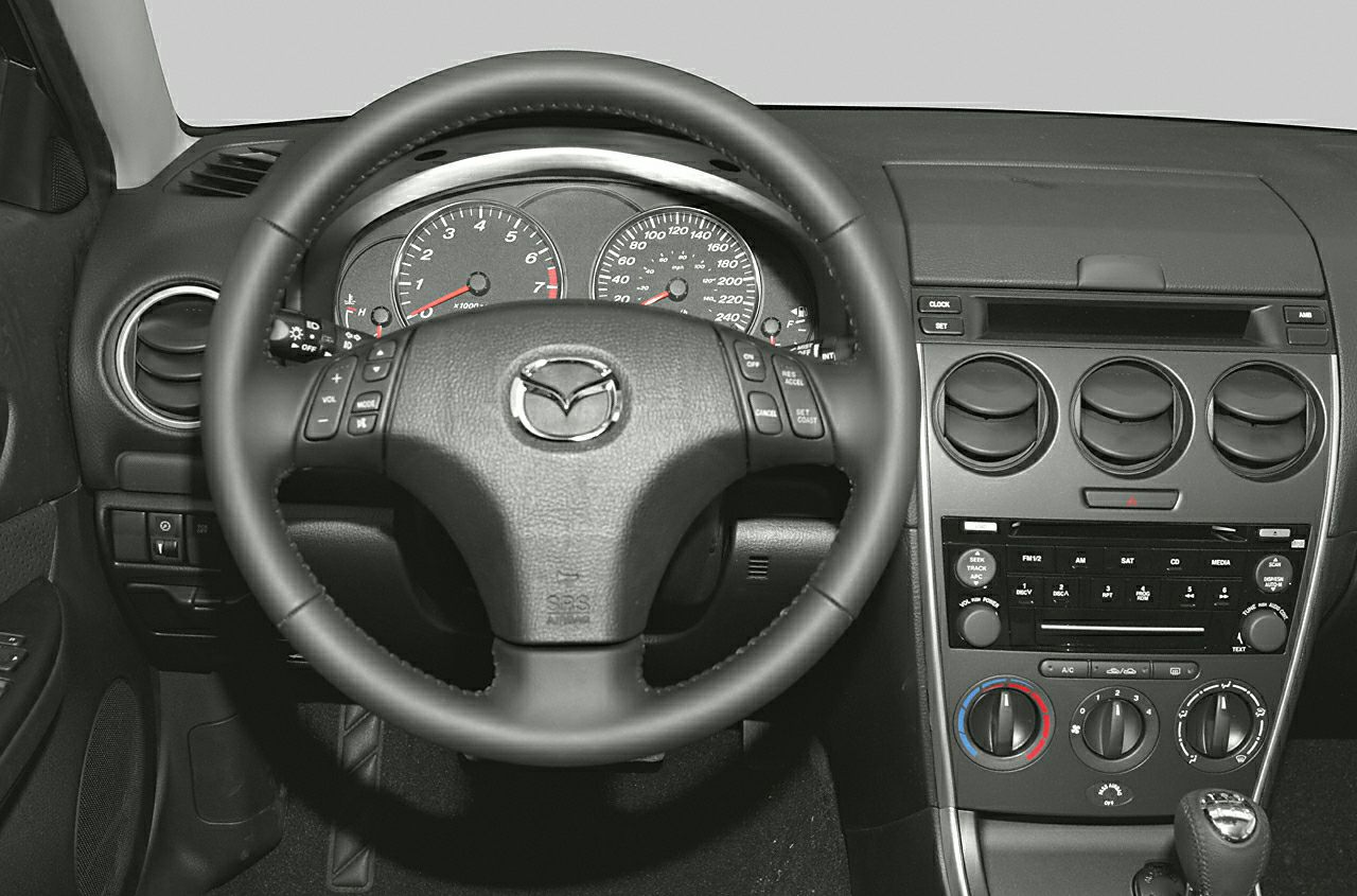 Dashboard, steering wheel with controls, and center console air vents