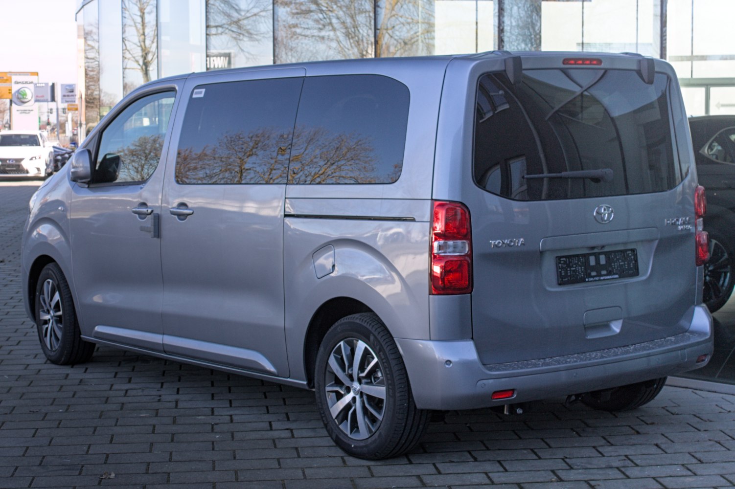 Rear and side view of a mid-size van with tinted windows and alloy wheels