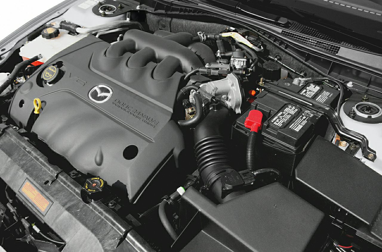 Engine bay with DOHC 16-valve engine and battery