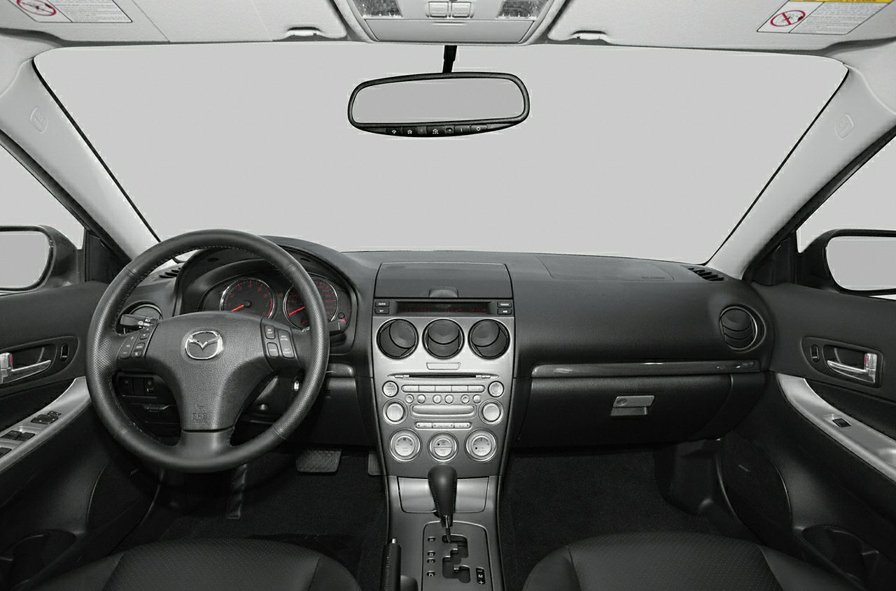 Dashboard and steering wheel of mid-2000s hatchback car interior