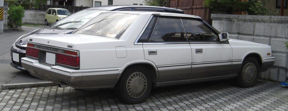 Boxy rear side view of 1980s sedan with distinctive taillights and trim