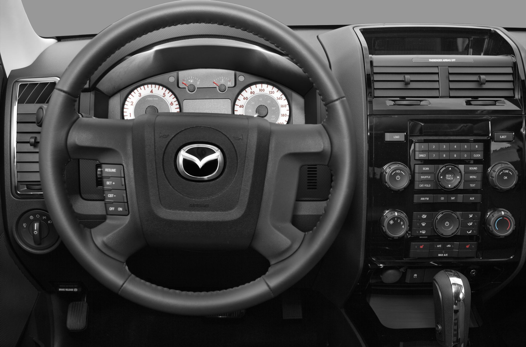 Multifunction steering wheel and detailed car dashboard with instrument cluster and control panel.