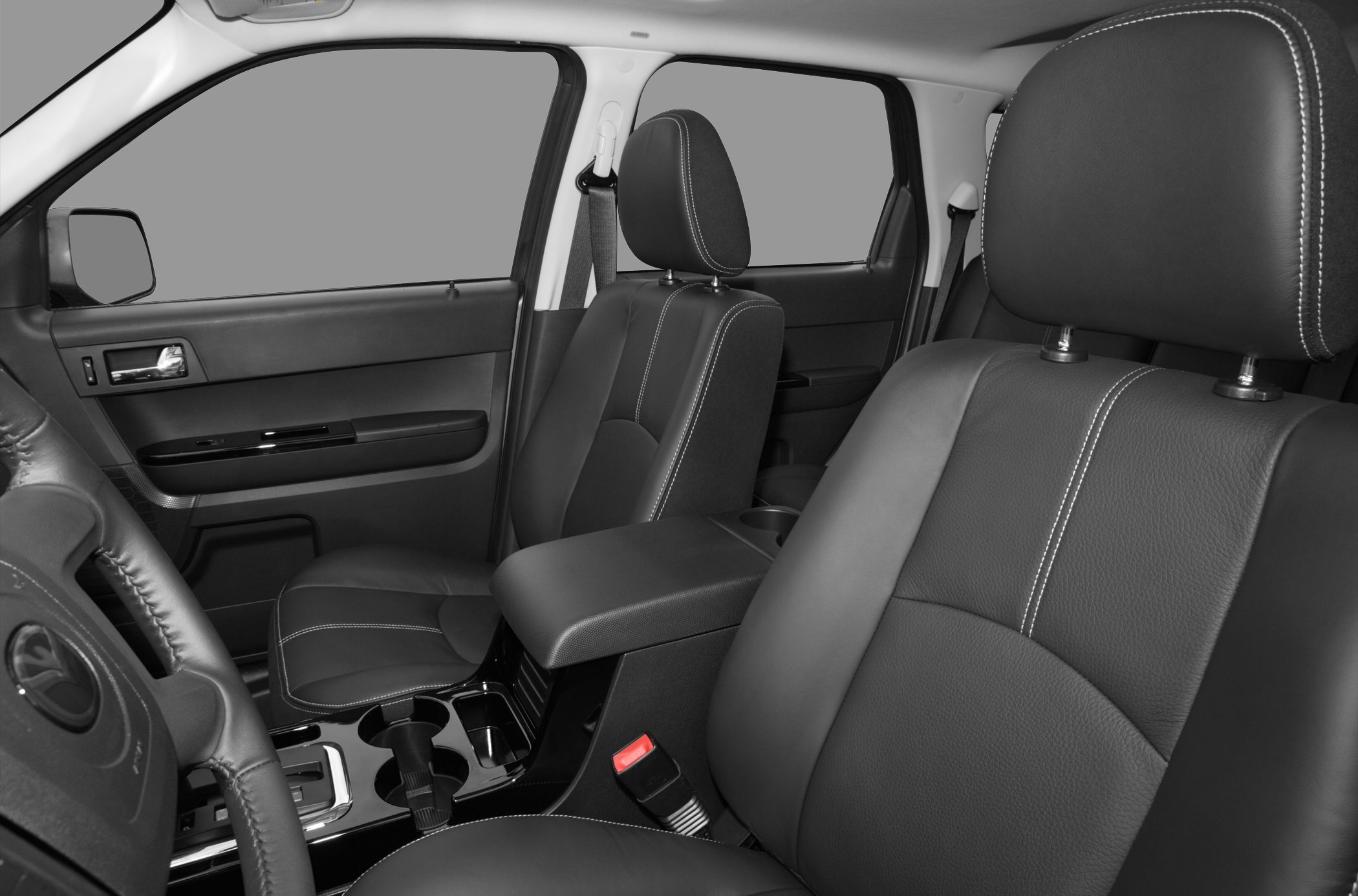 Black leather front seats with white stitching and central armrest