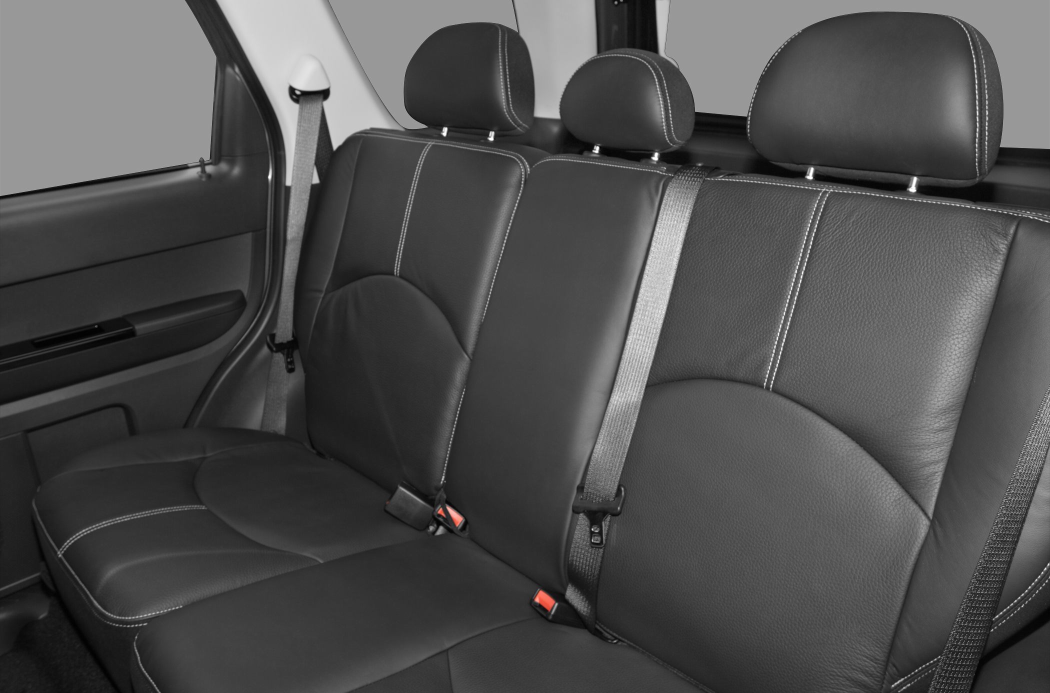 Black leather rear seats with headrests and visible seat belts.
