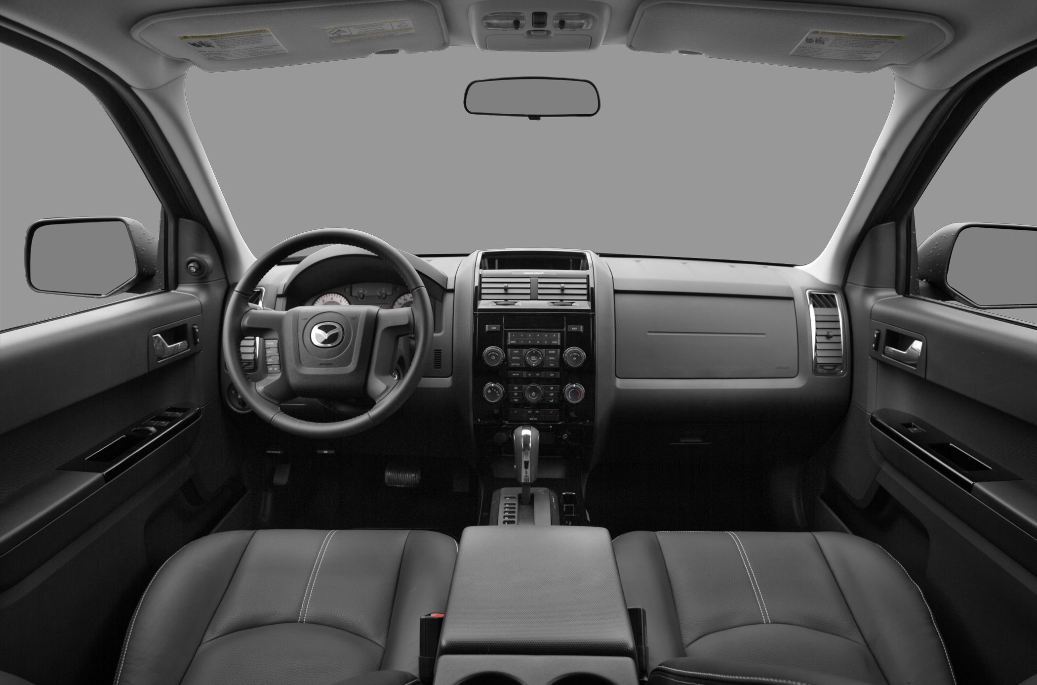 Car interior with dashboard, steering wheel, and front seats