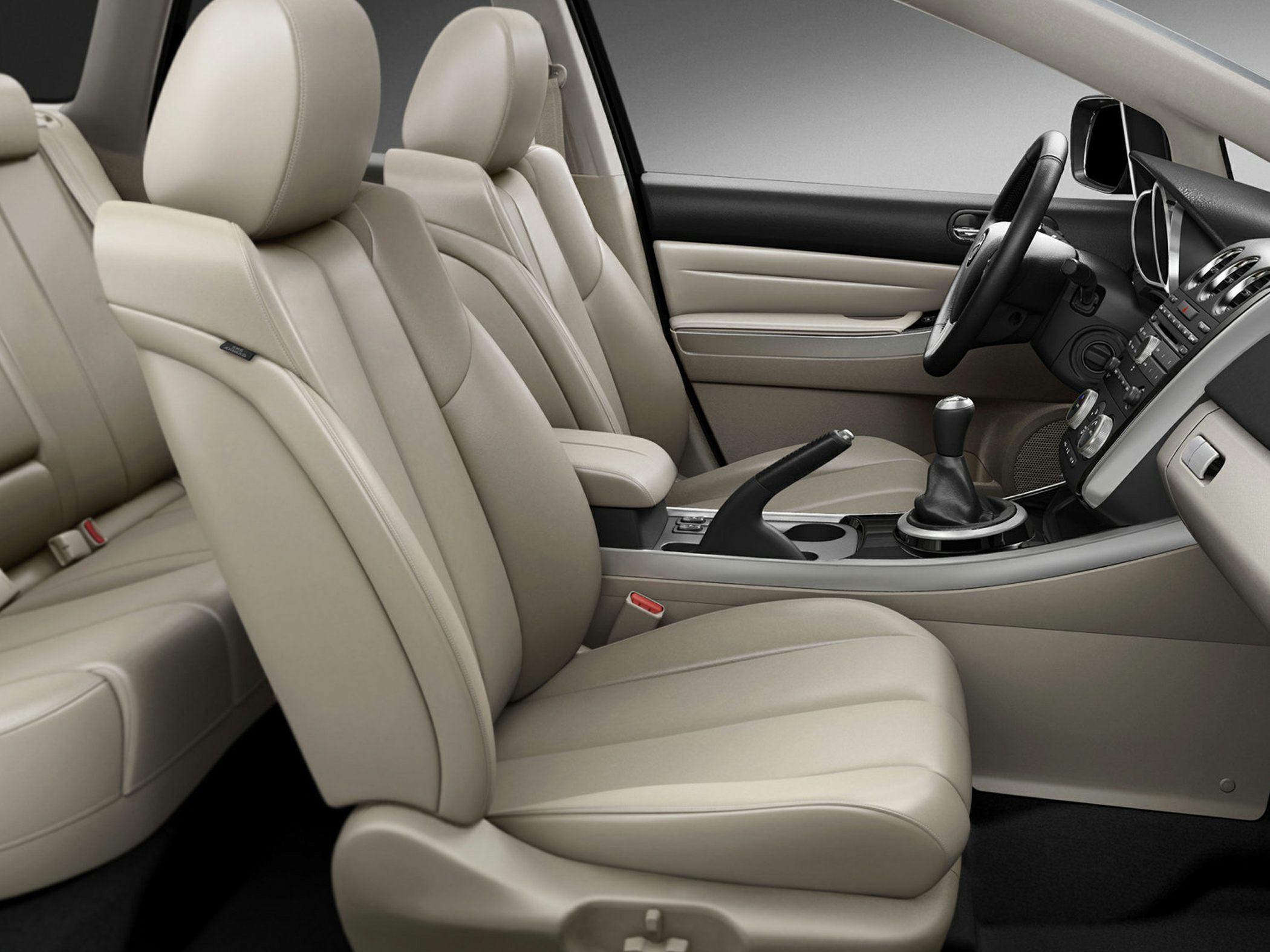 Beige leather seats and center console with gear shift and handbrake