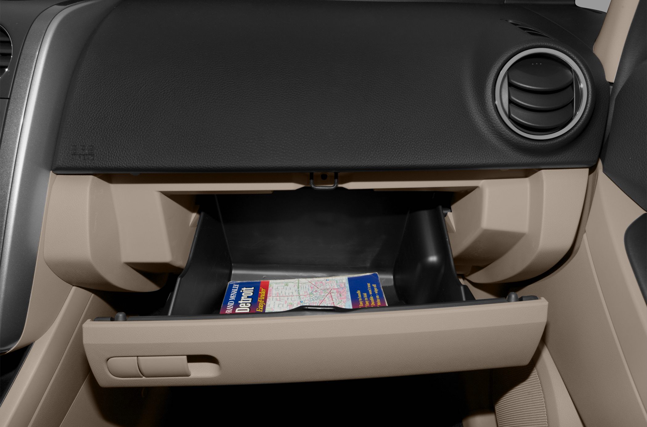 Open glove compartment with map inside in a car interior