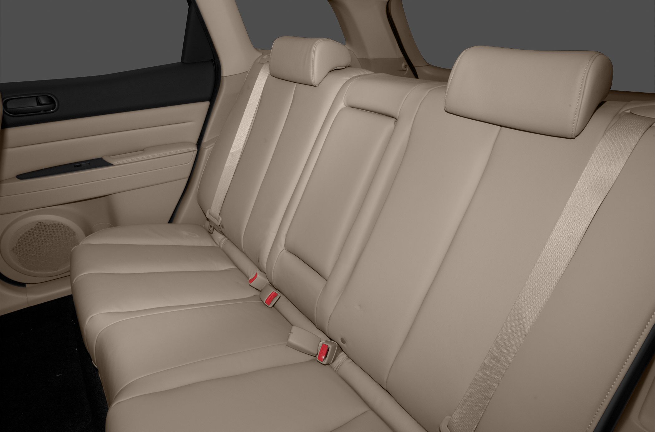 Rear seating with beige leather upholstery, seat belts, and headrests