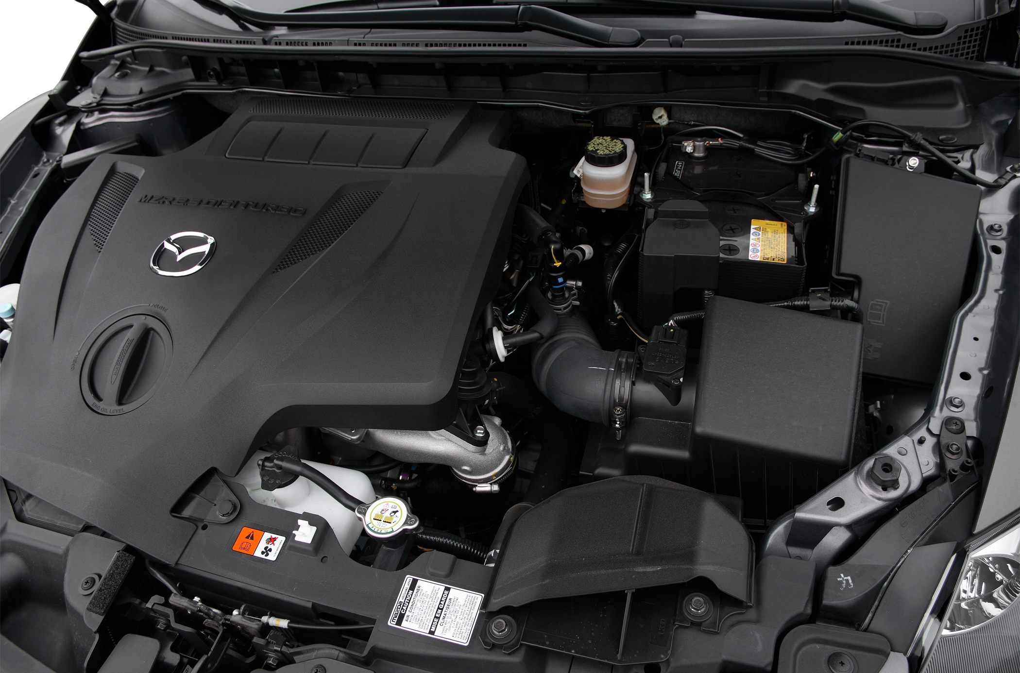 Turbocharged engine bay with Mazda emblem and components