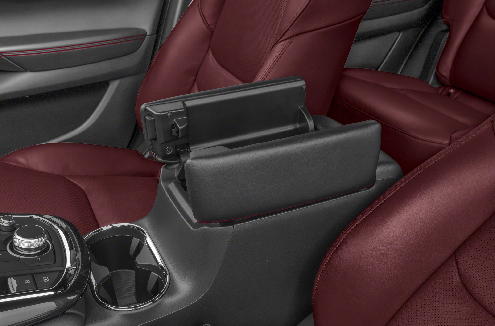 Black armrest and cup holder on red leather seats